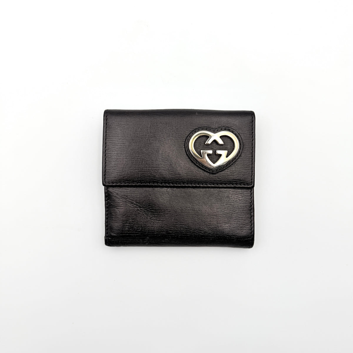 Gucci Interlocking G Heart Bifold Wallet in black leather with iconic silver-tone heart logo on the front flap.