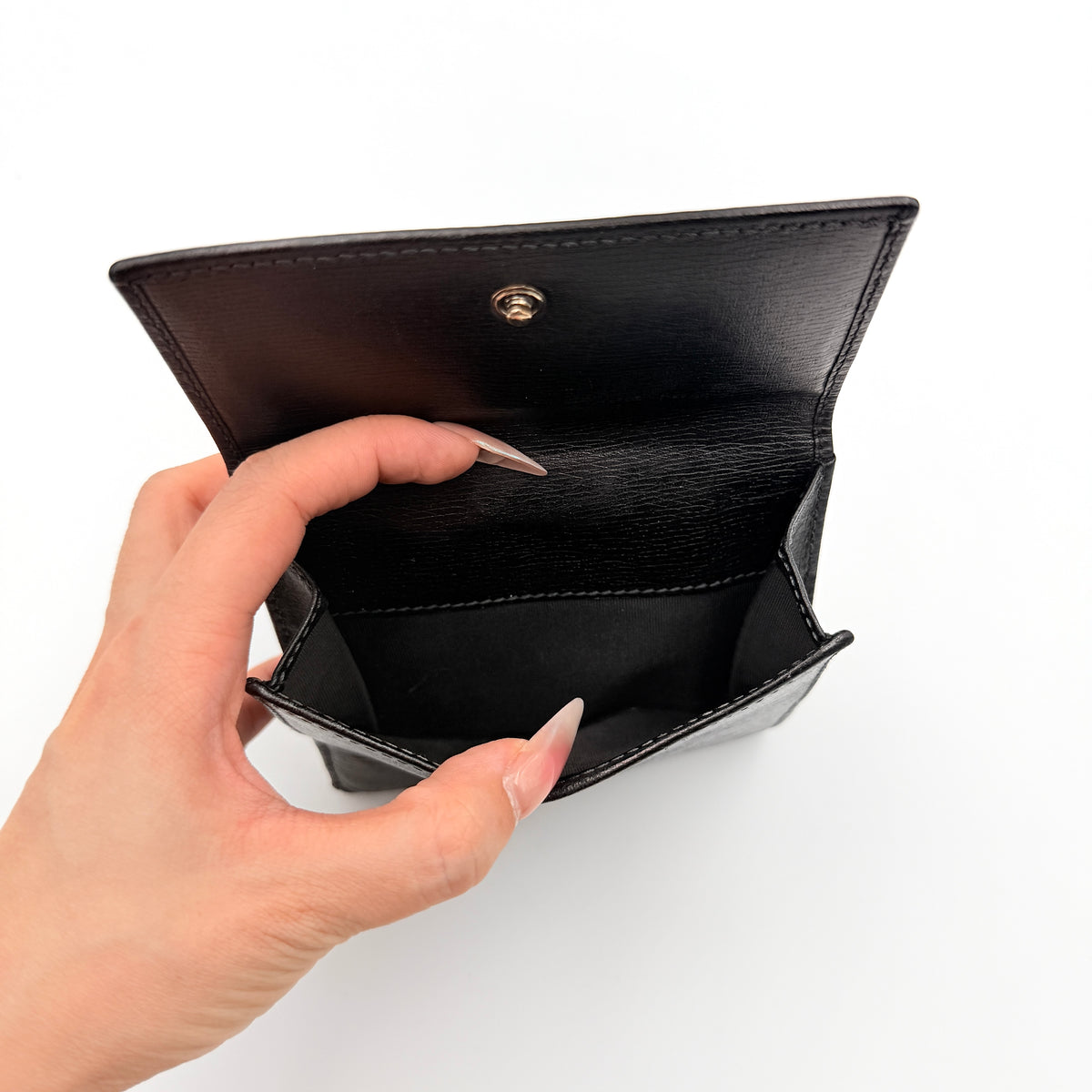 Gucci Interlocking G Heart Bifold Wallet in black leather with iconic silver-tone heart logo on the front flap.