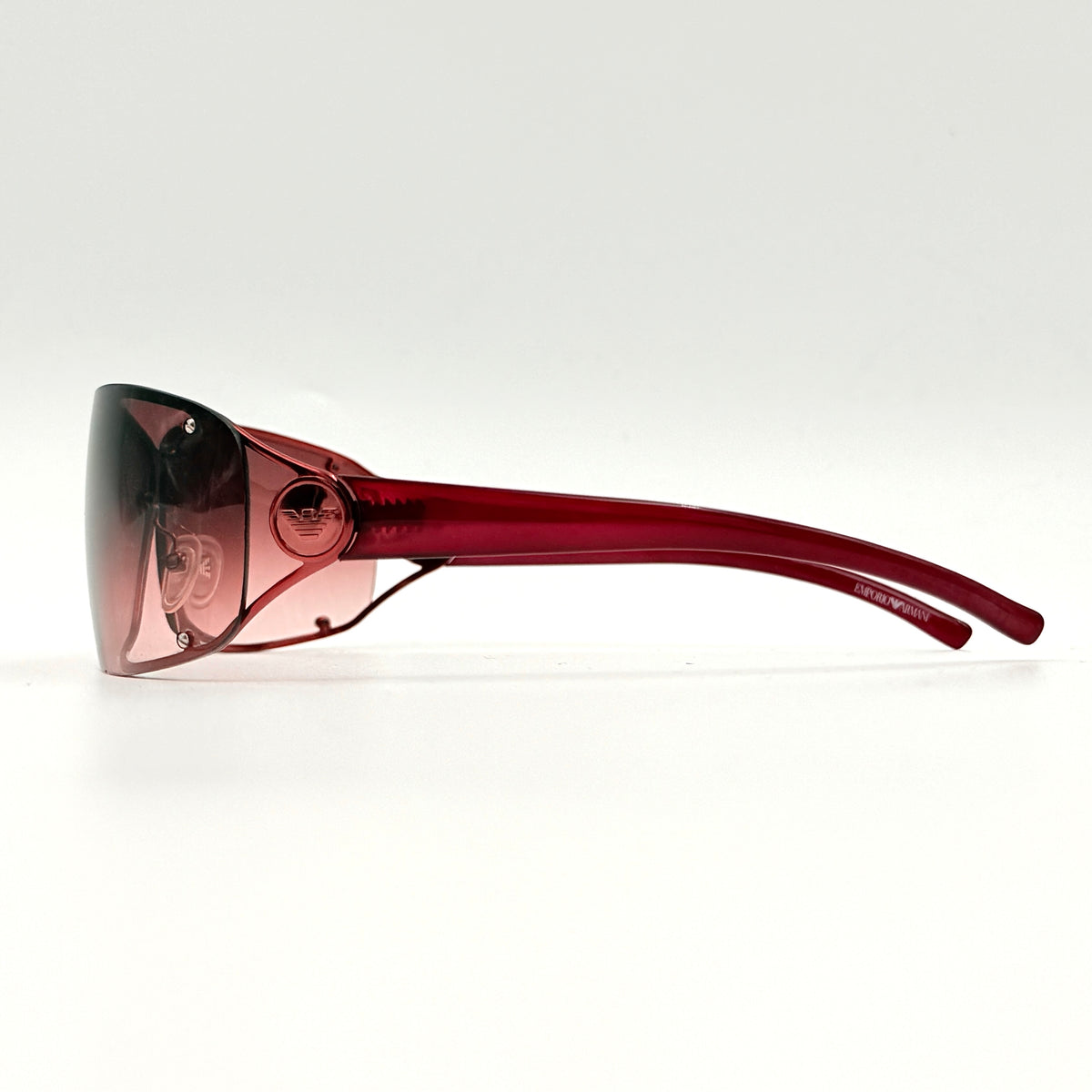 Emporio Armani EA 9251/S sunglasses in translucent red with gradient lenses and silver-tone logo detail at the temple.