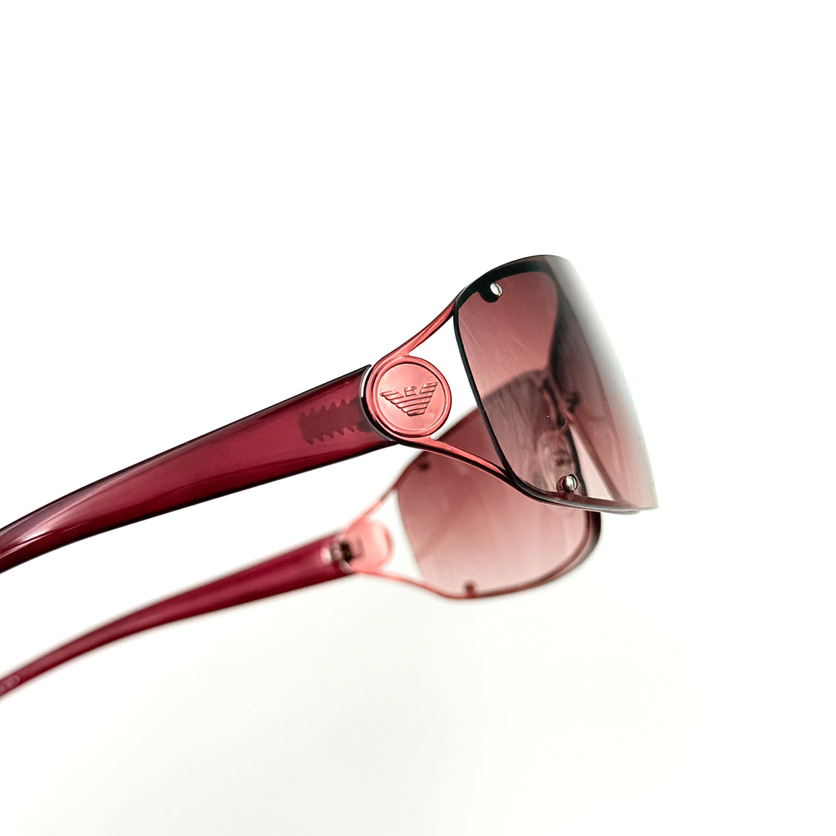 Emporio Armani EA 9251/S sunglasses in translucent red with gradient lenses and silver-tone logo detail at the temple.