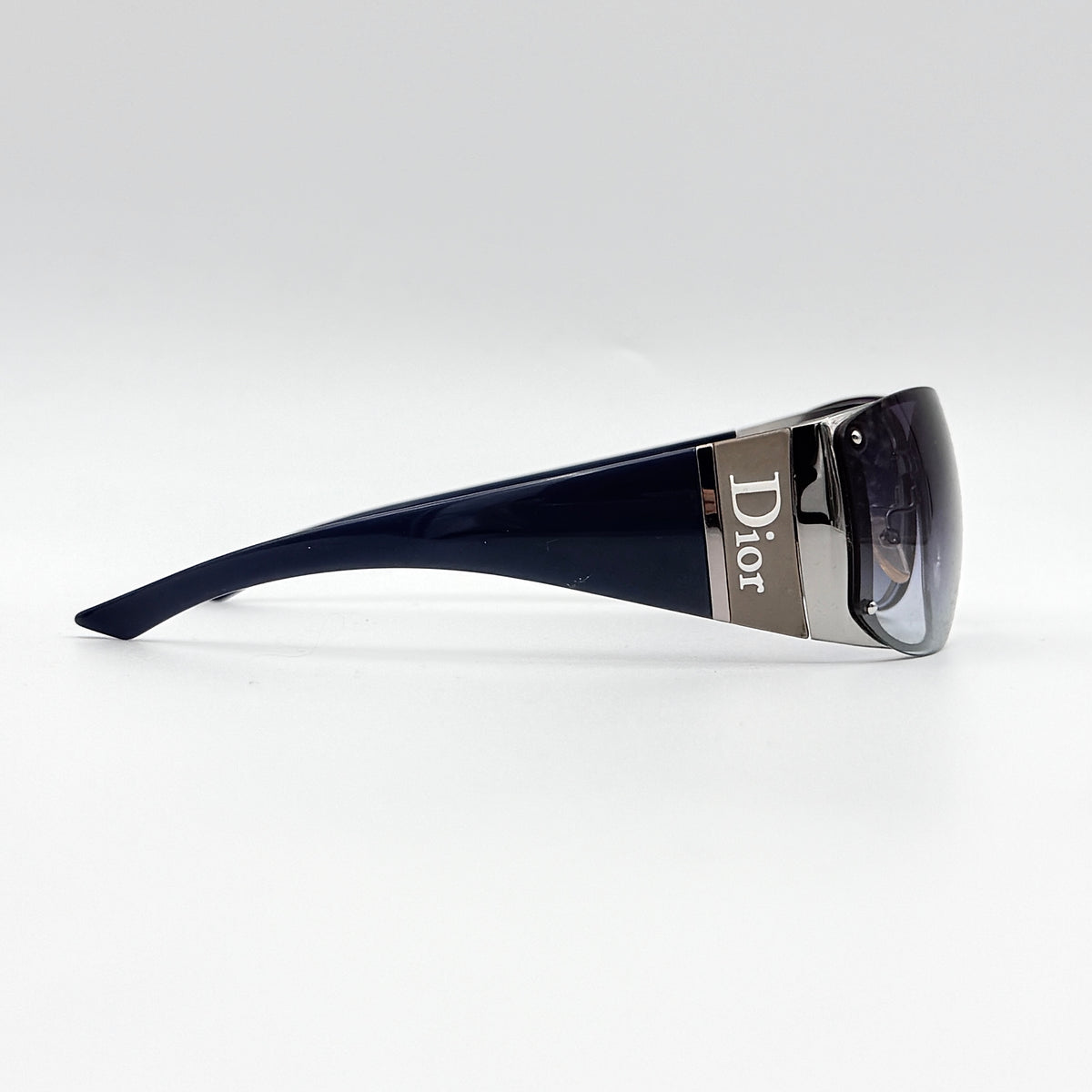 Christian Dior SUBDIOR 1/F sunglasses in navy blue with wide arms, gradient lenses, and silver-tone logo detail at the temples.