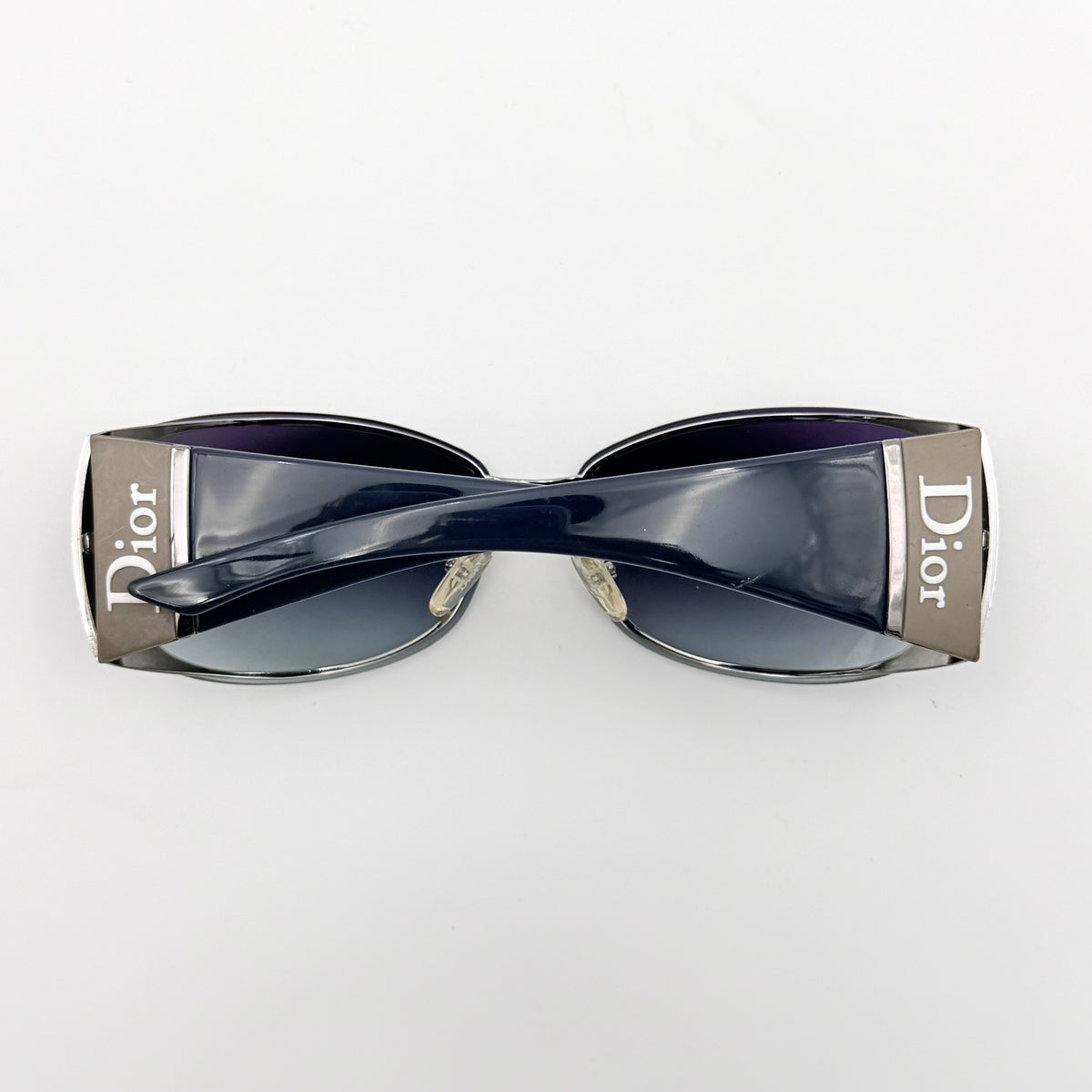 Christian Dior SUBDIOR 1/F sunglasses in navy blue with wide arms, gradient lenses, and silver-tone logo detail at the temples.