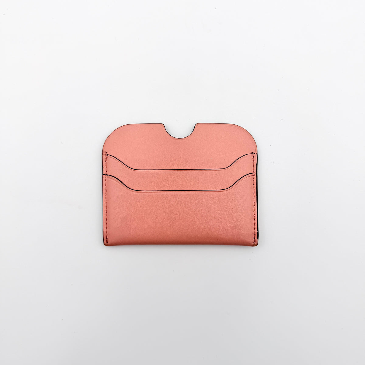 Acne Studios pink leather card holder with embossed logo and double card slots, shown against a clean white background.