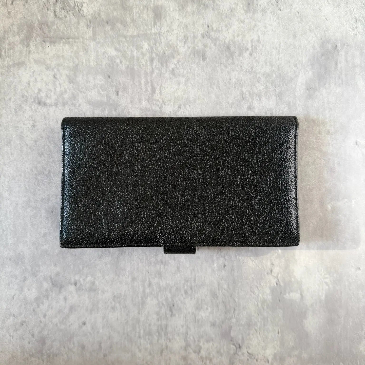 Bvlgari Black Leather Signature Ring Fold Long Wallet with a logo ring closure and red interior.