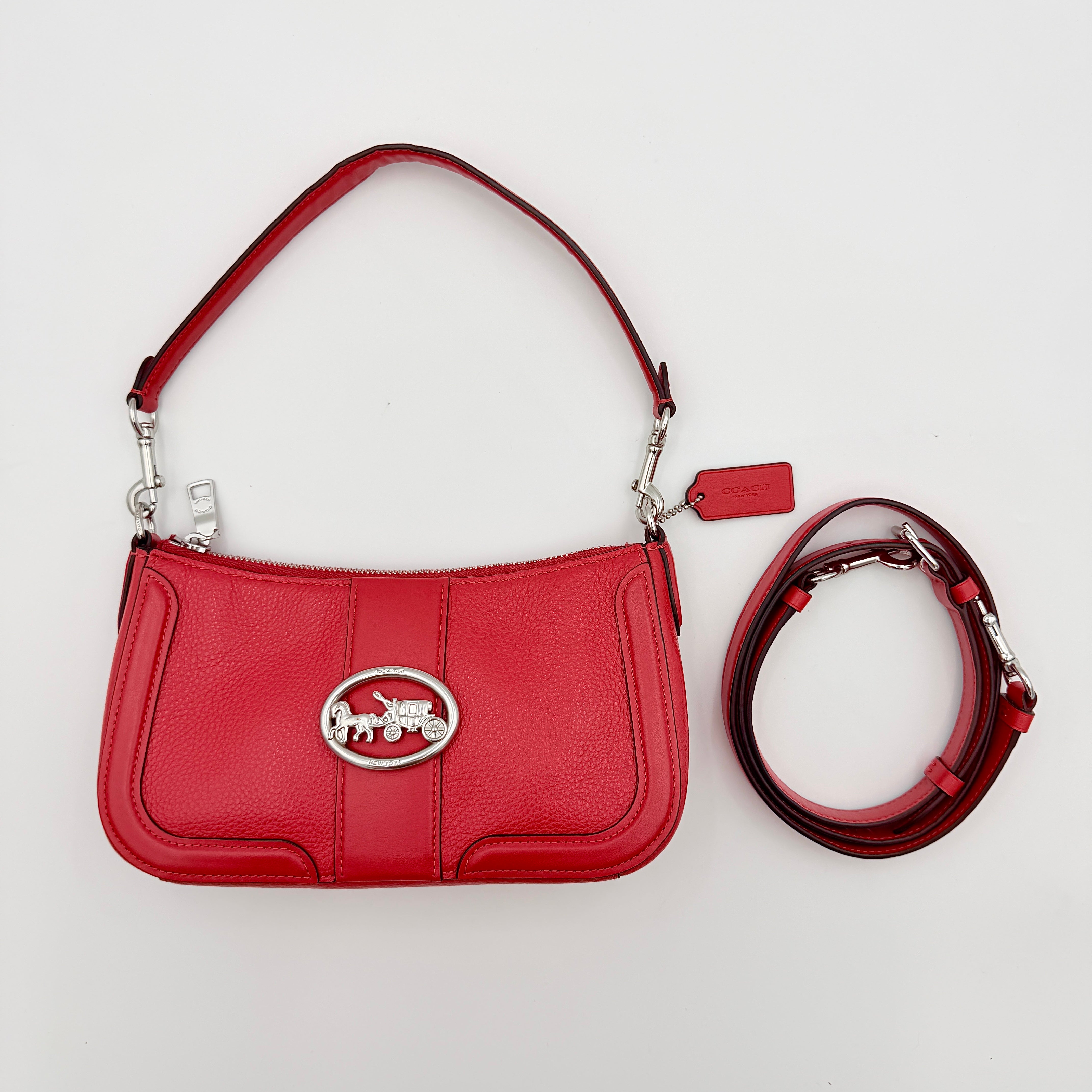 Coach 2Way Georgie Baguette in red pebbled leather with silver carriage logo hardware, shown with removable shoulder strap.