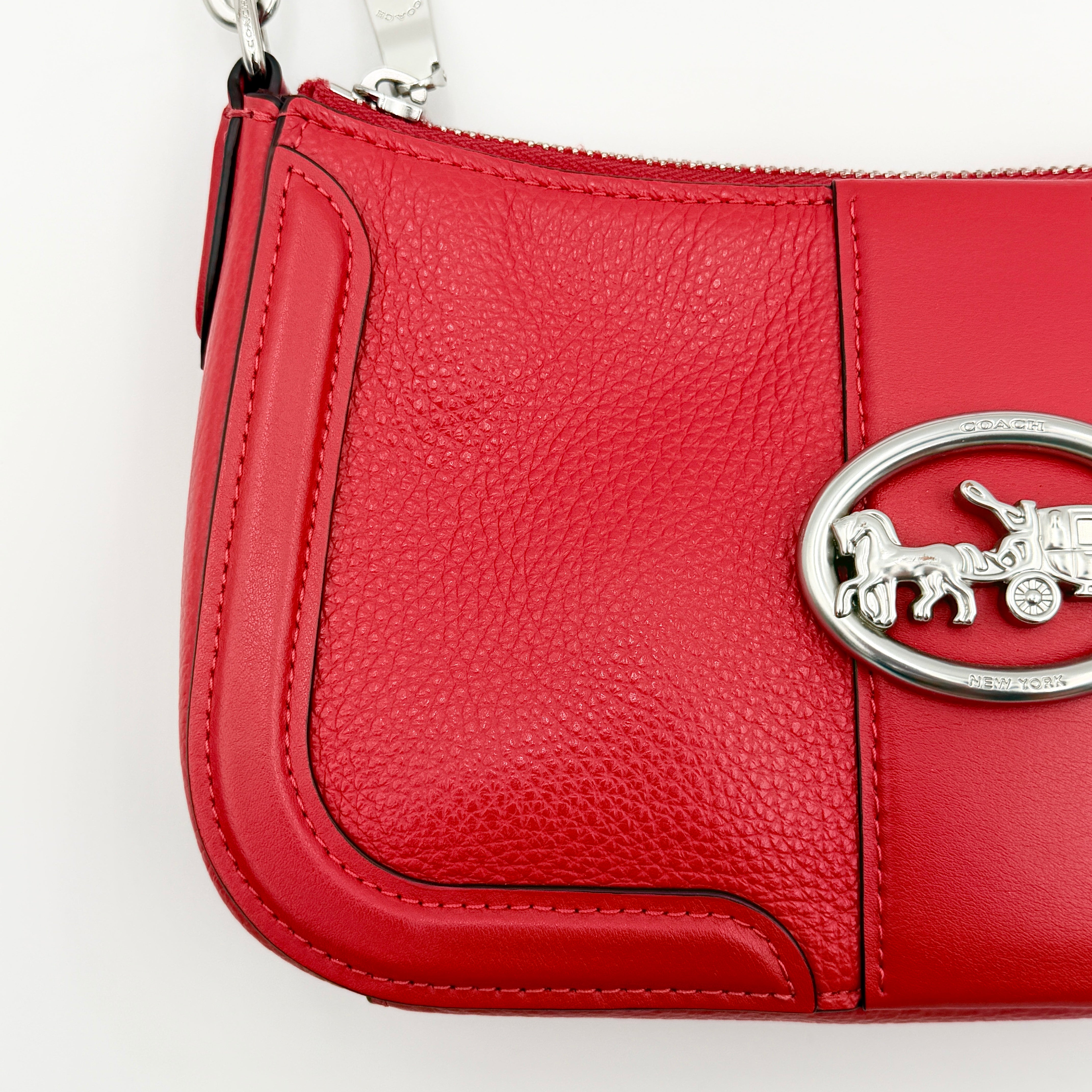 Coach 2Way Georgie Baguette in red pebbled leather with silver carriage logo hardware, shown with removable shoulder strap.