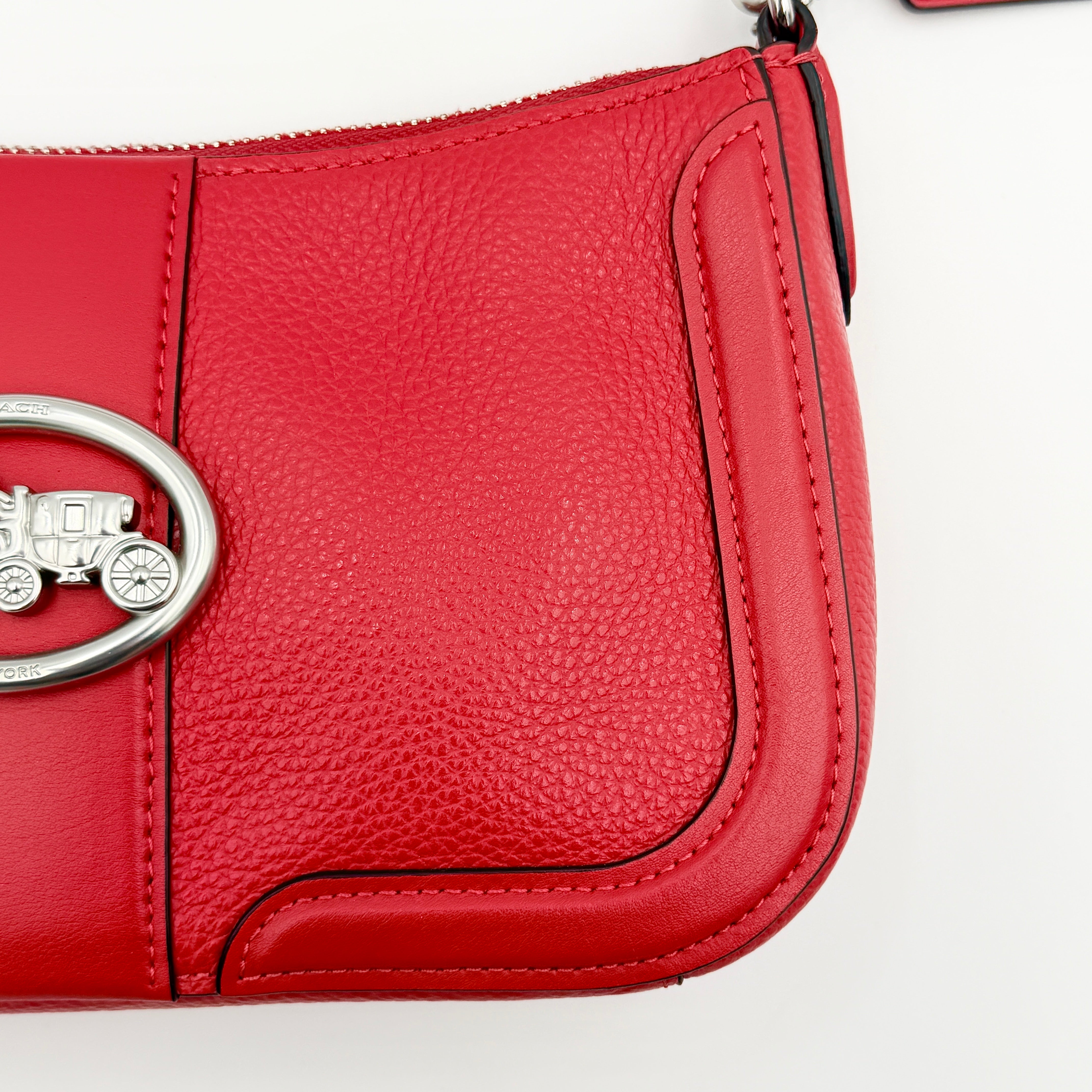 Coach 2Way Georgie Baguette in red pebbled leather with silver carriage logo hardware, shown with removable shoulder strap.
