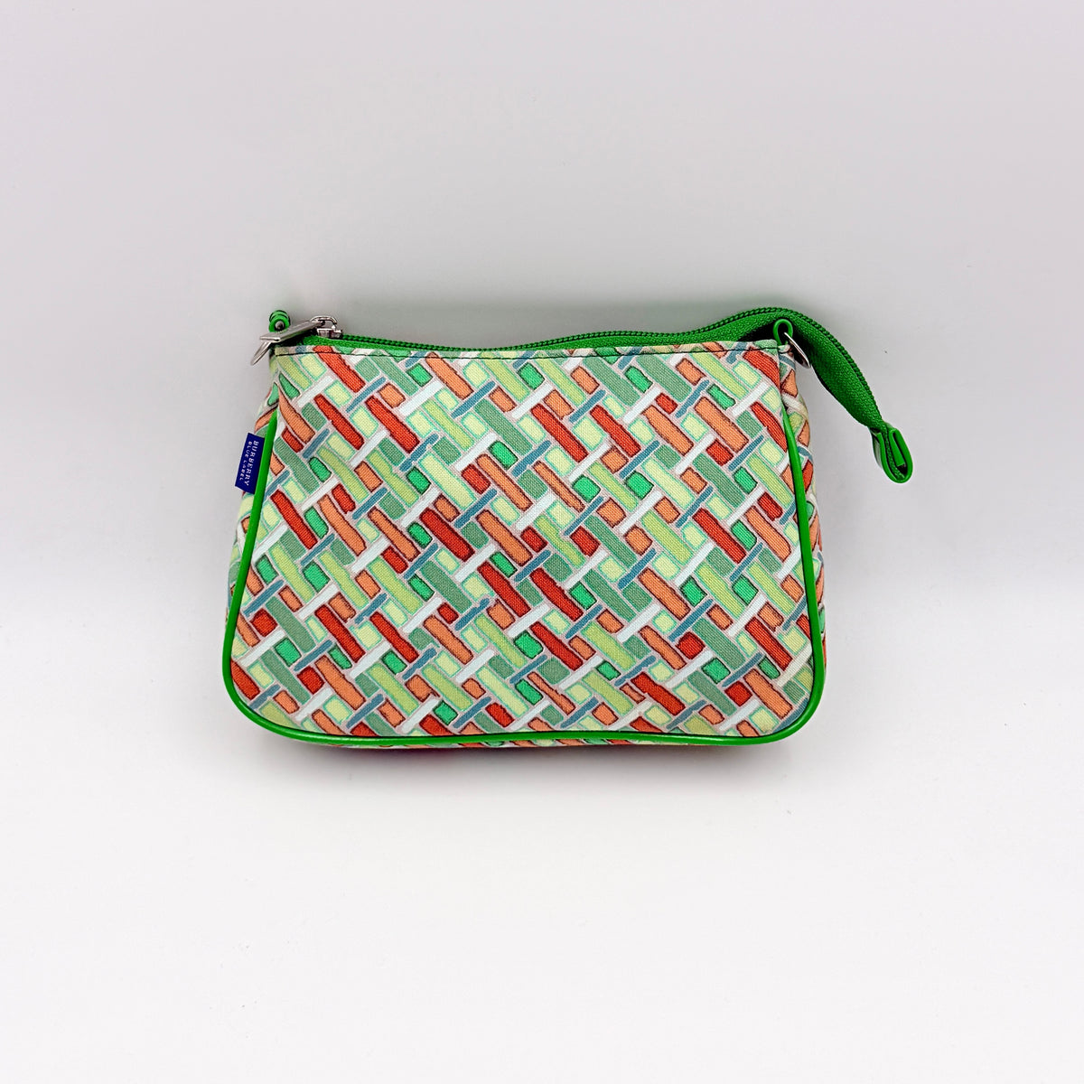 Burberry Blue Label geometric pouch in multicolor canvas with green trim and zip closure, photographed against a clean white background.