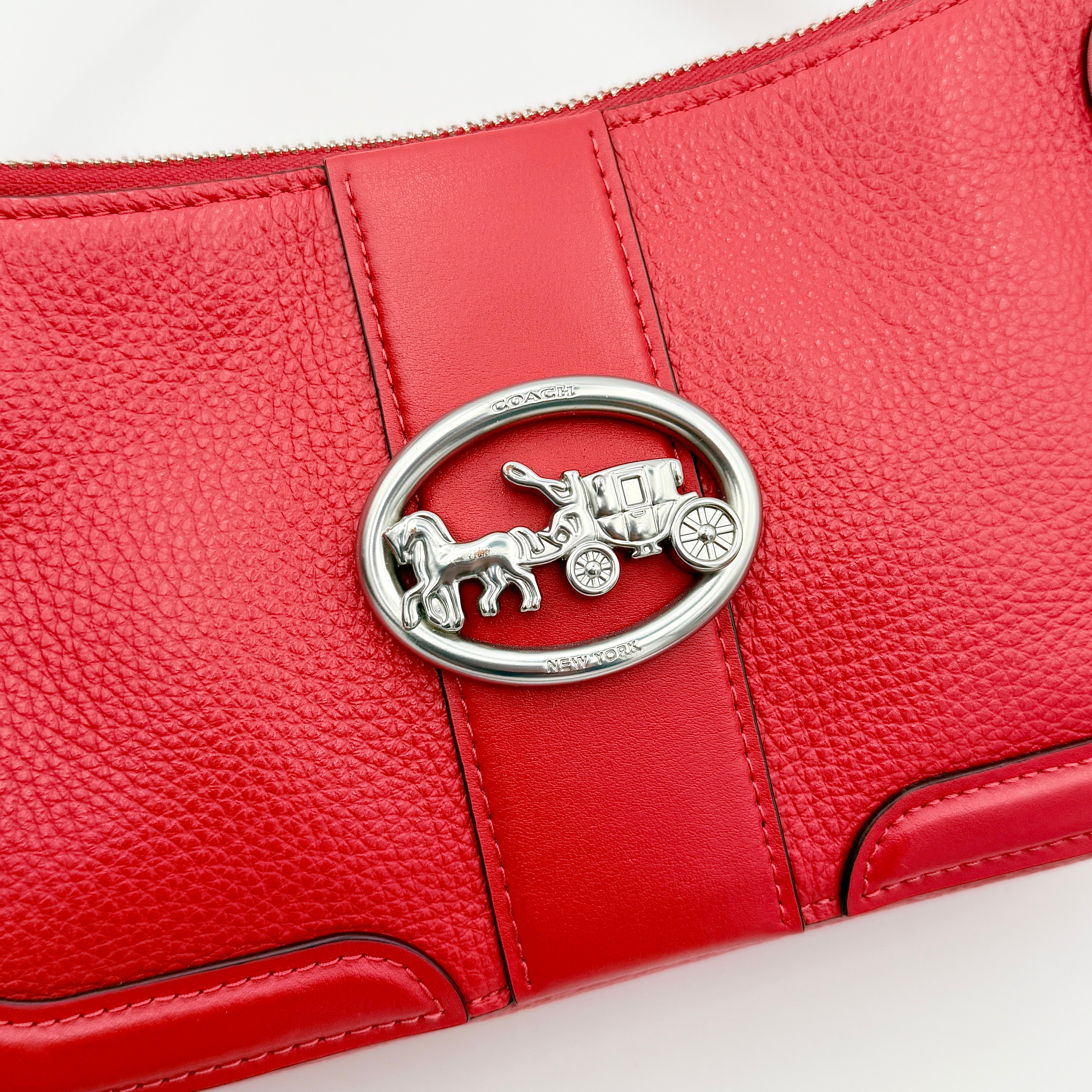 Coach 2Way Georgie Baguette in red pebbled leather with silver carriage logo hardware, shown with removable shoulder strap.