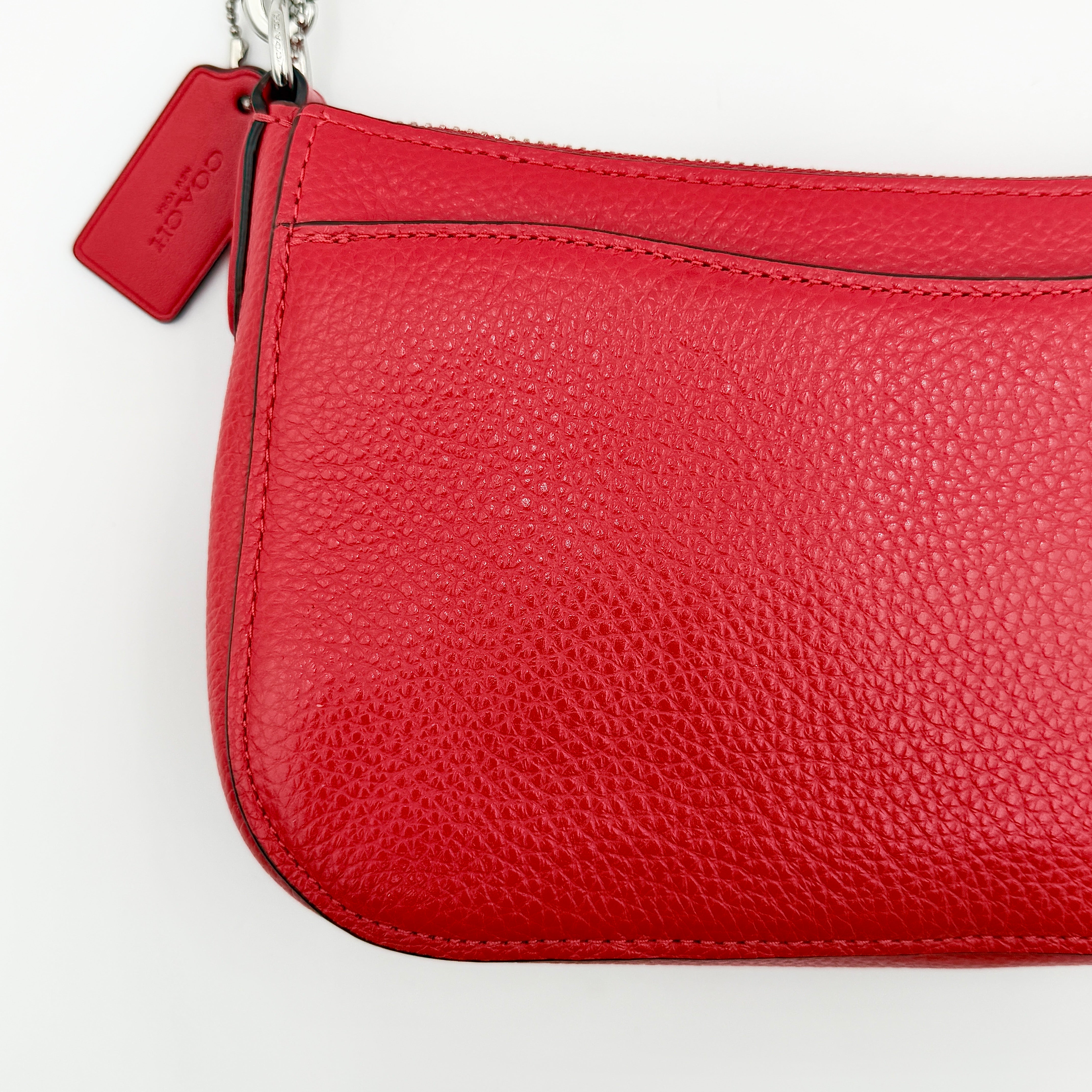 Coach 2Way Georgie Baguette in red pebbled leather with silver carriage logo hardware, shown with removable shoulder strap.