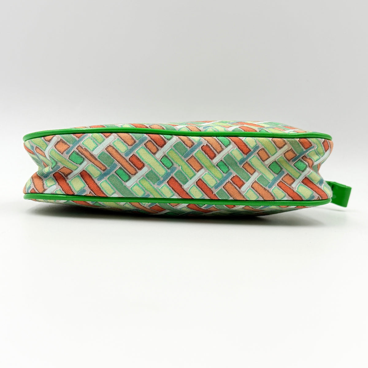 Burberry Blue Label geometric pouch in multicolor canvas with green trim and zip closure, photographed against a clean white background.