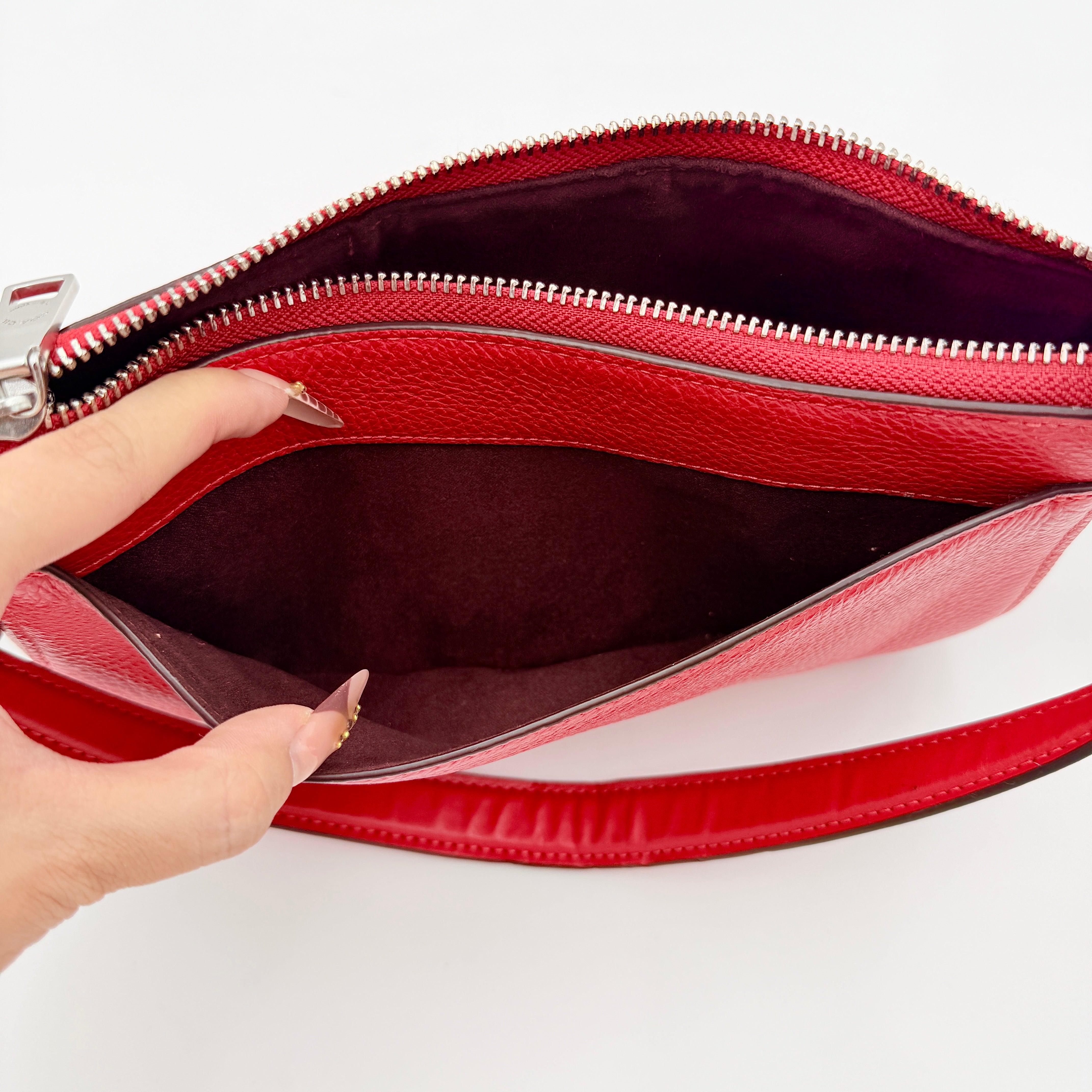 Coach 2Way Georgie Baguette in red pebbled leather with silver carriage logo hardware, shown with removable shoulder strap.