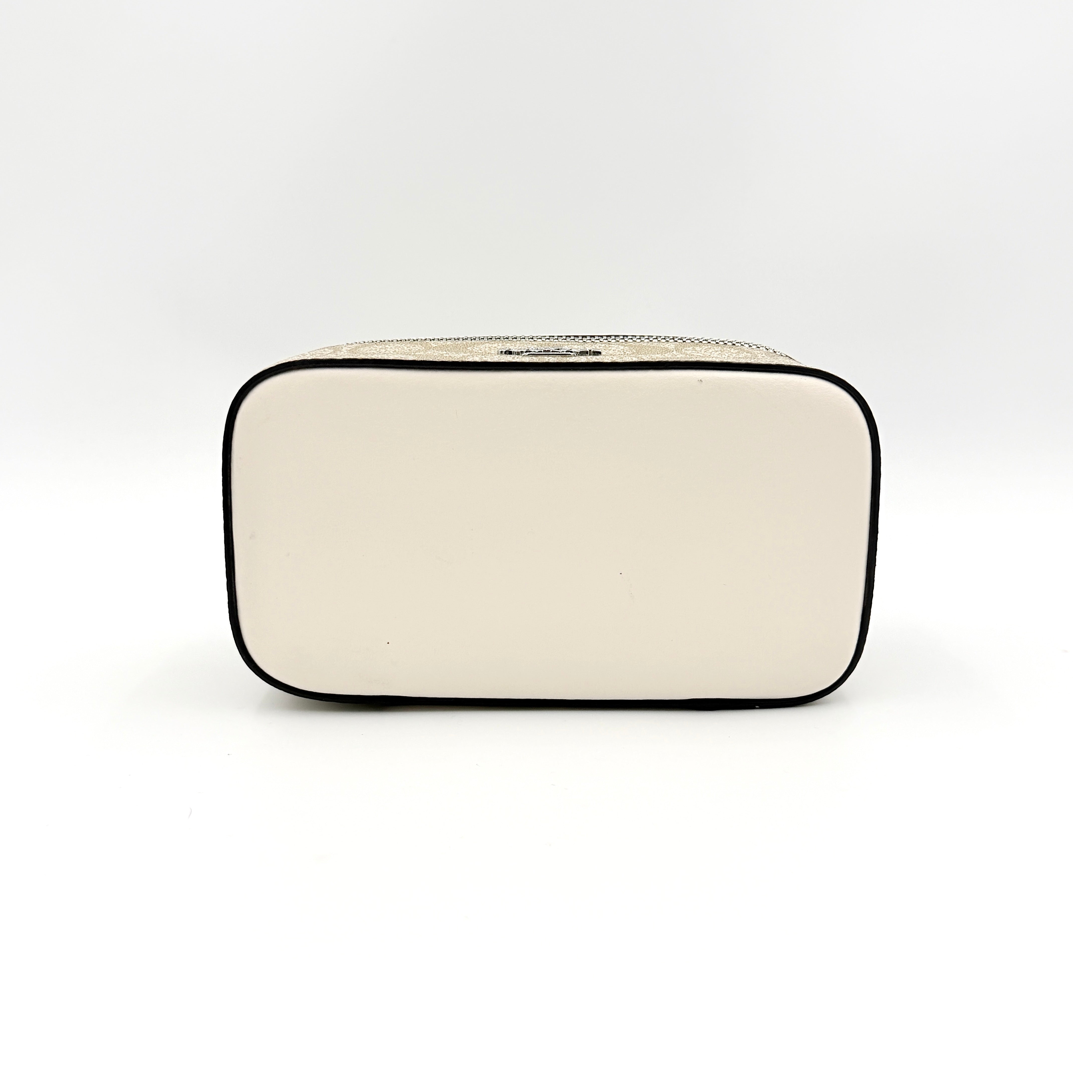 Coach 2Way Signature Train Case in beige and white canvas with a leather top handle and detachable strap, shown with silver zip hardware.