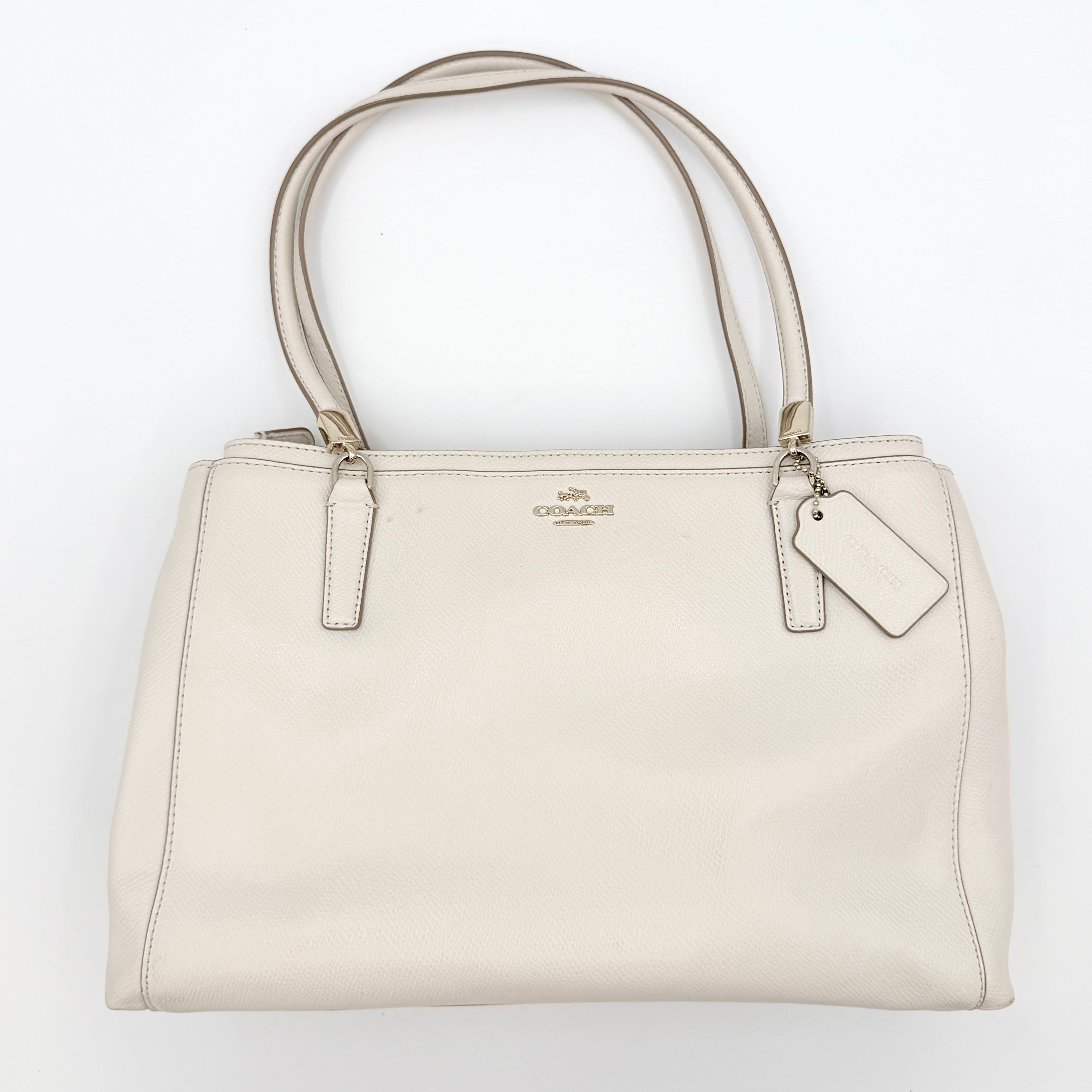 Coach Parker 16 shoulder bag in white leather with dual top handles and gold-tone accents, displayed against a clean background.