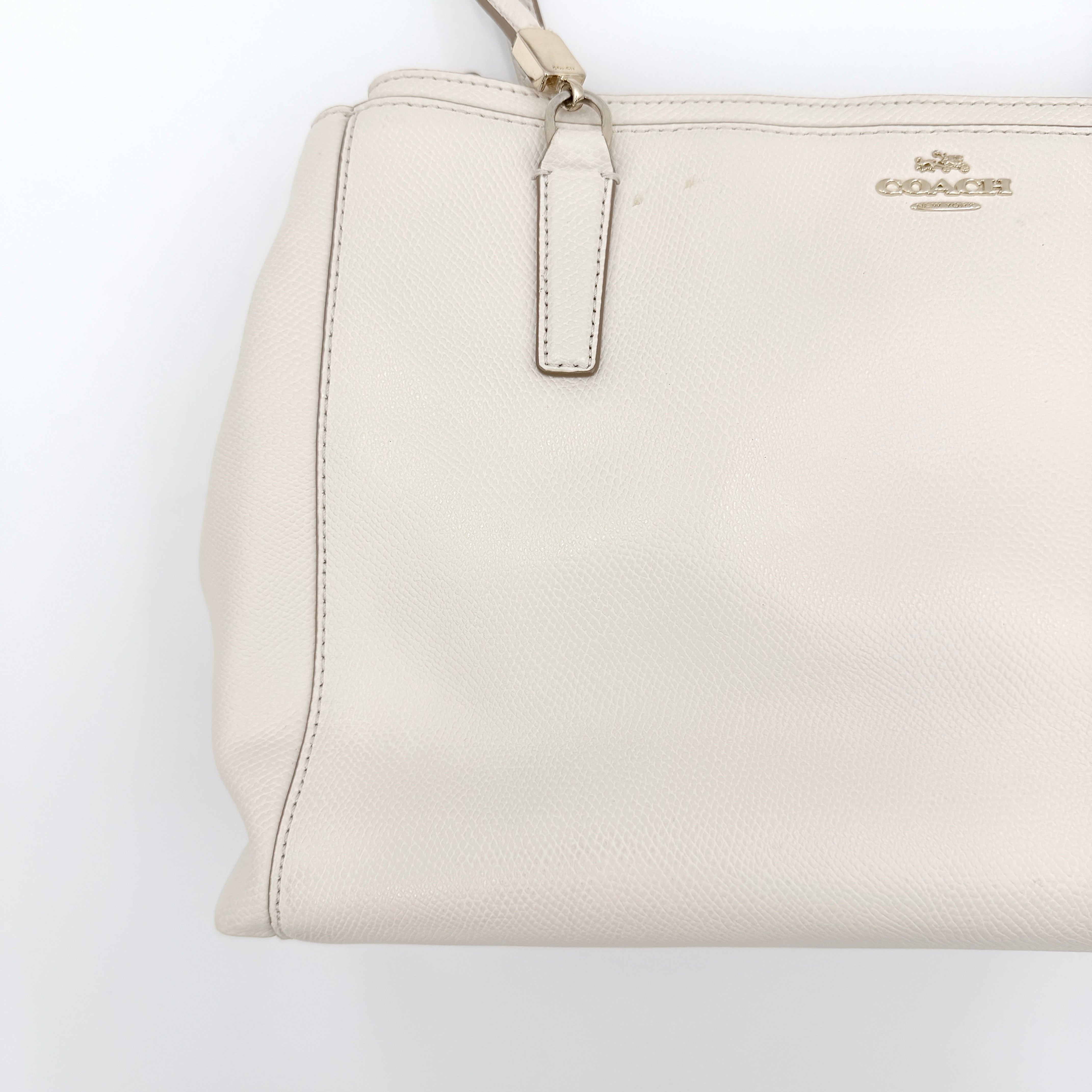 Coach Parker 16 shoulder bag in white leather with dual top handles and gold-tone accents, displayed against a clean background.
