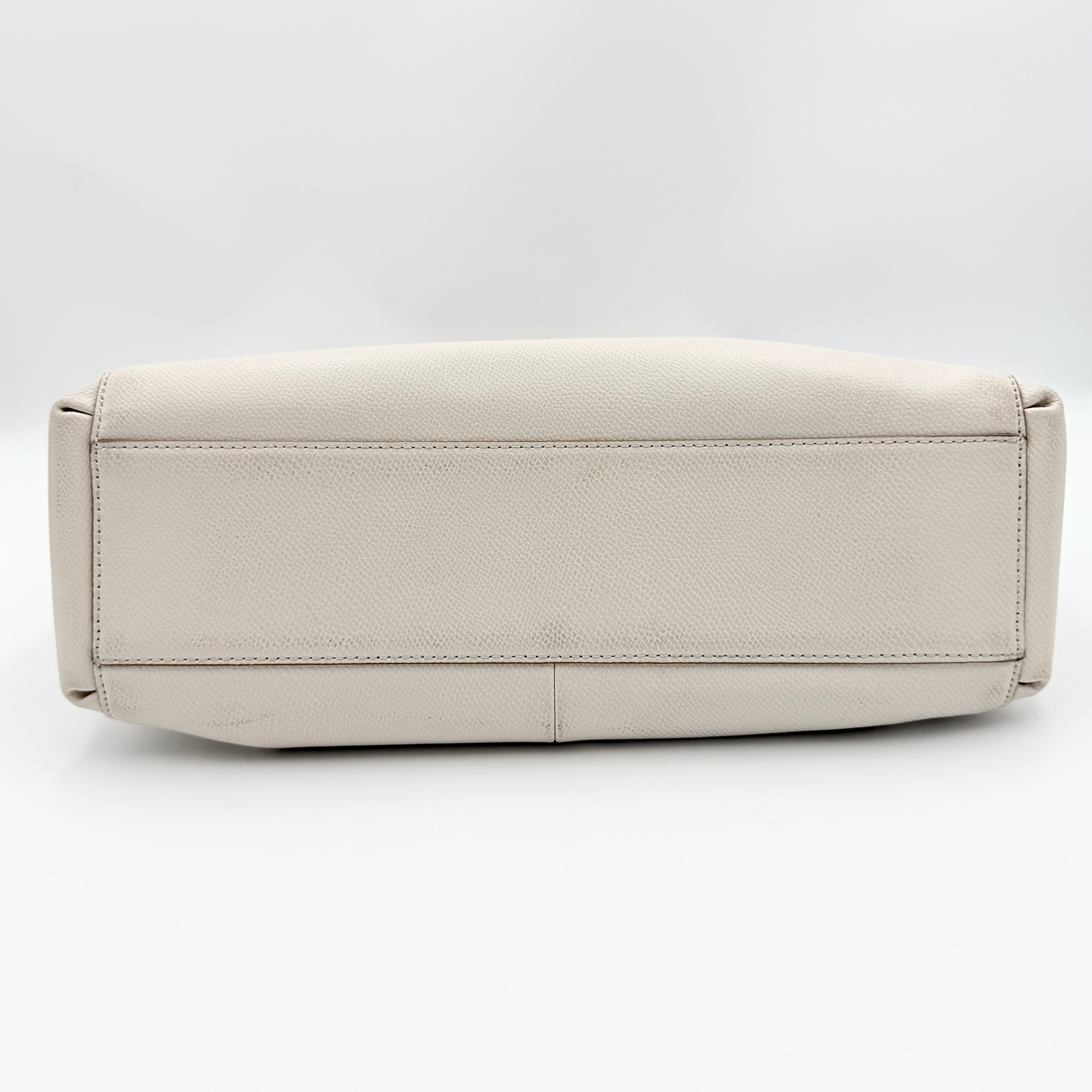Coach Parker 16 shoulder bag in white leather with dual top handles and gold-tone accents, displayed against a clean background.