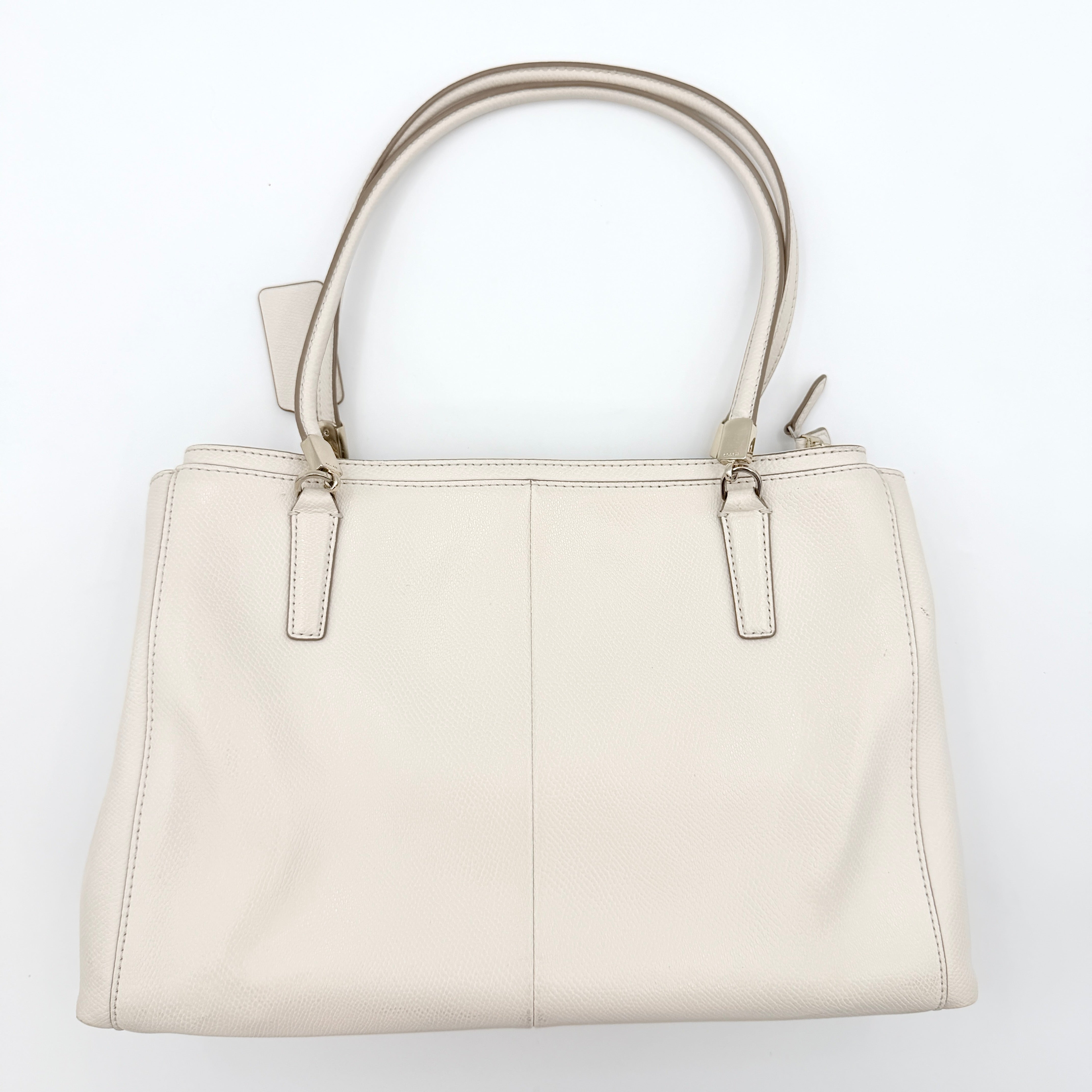 Coach Parker 16 shoulder bag in white leather with dual top handles and gold-tone accents, displayed against a clean background.
