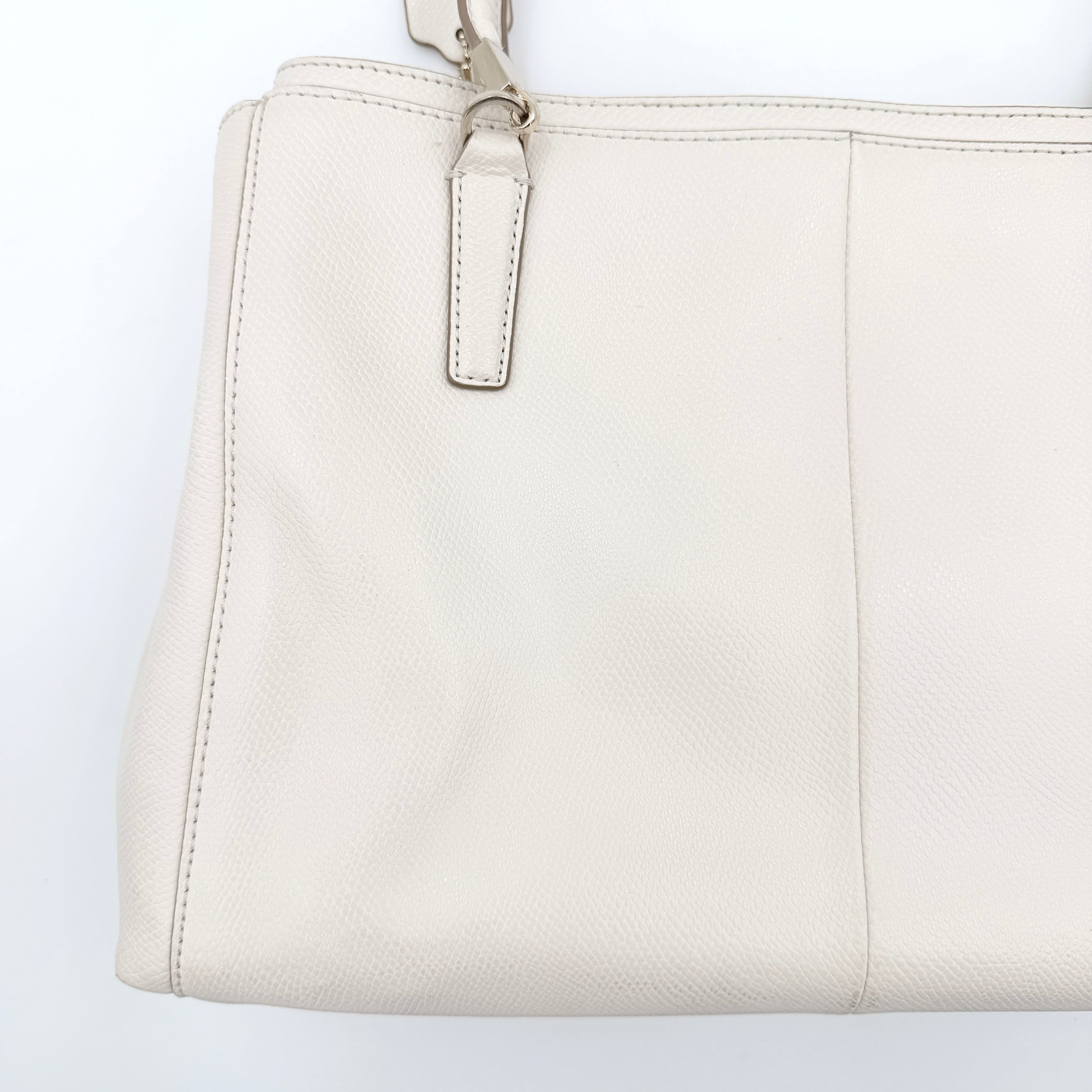 Coach Parker 16 shoulder bag in white leather with dual top handles and gold-tone accents, displayed against a clean background.