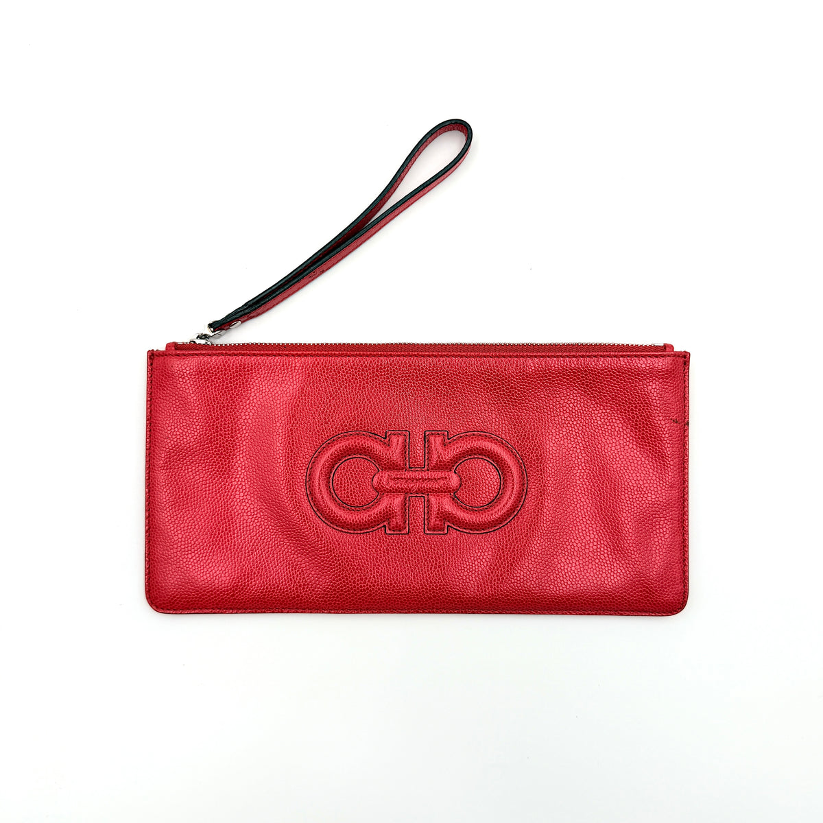 Salvatore Ferragamo red embossed leather wristlet with Gancini motif and wrist strap, shown against a white background.