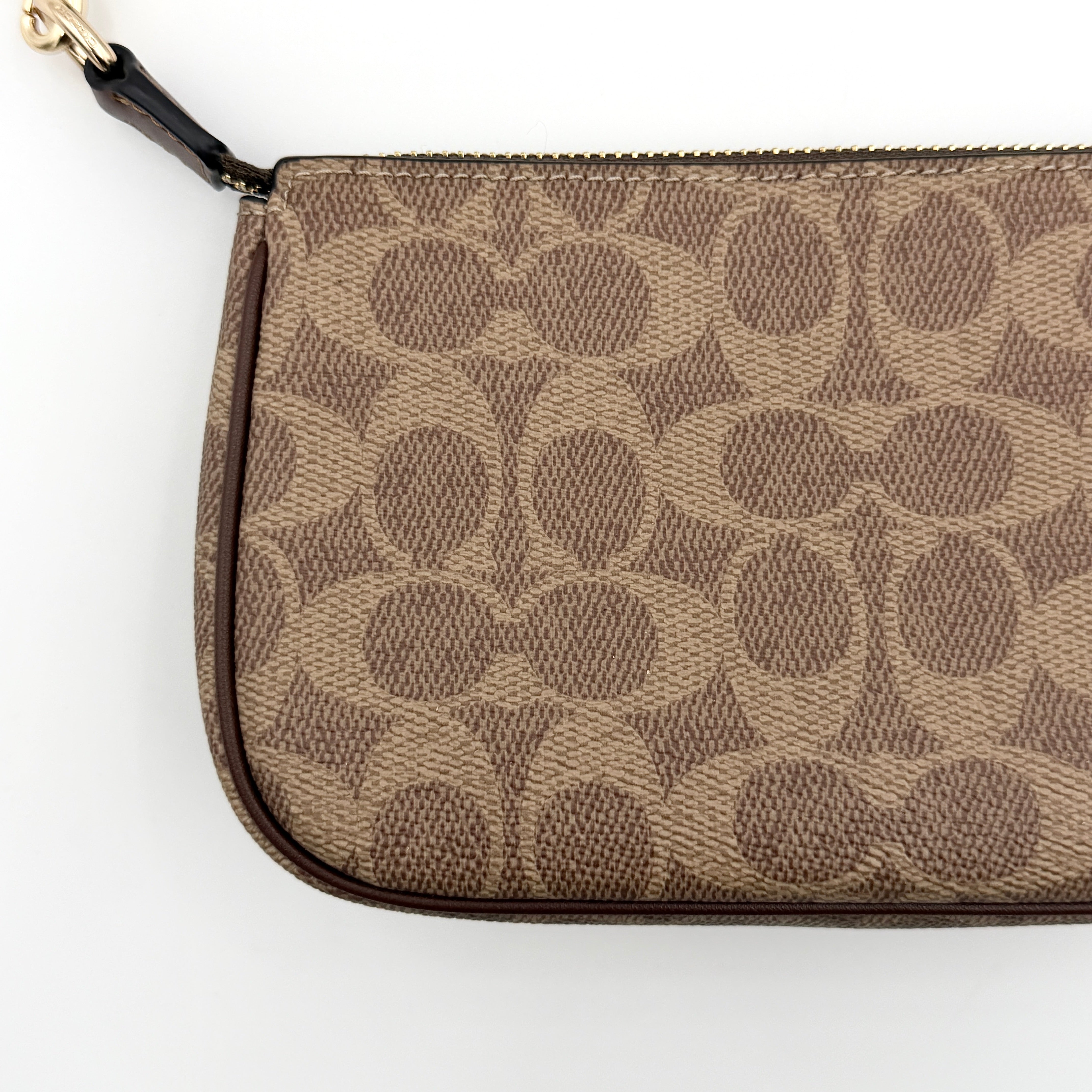 Coach Signature Nolita 19 Shoulder Bag in beige and brown canvas with gold tone hardware and detachable leather strap.