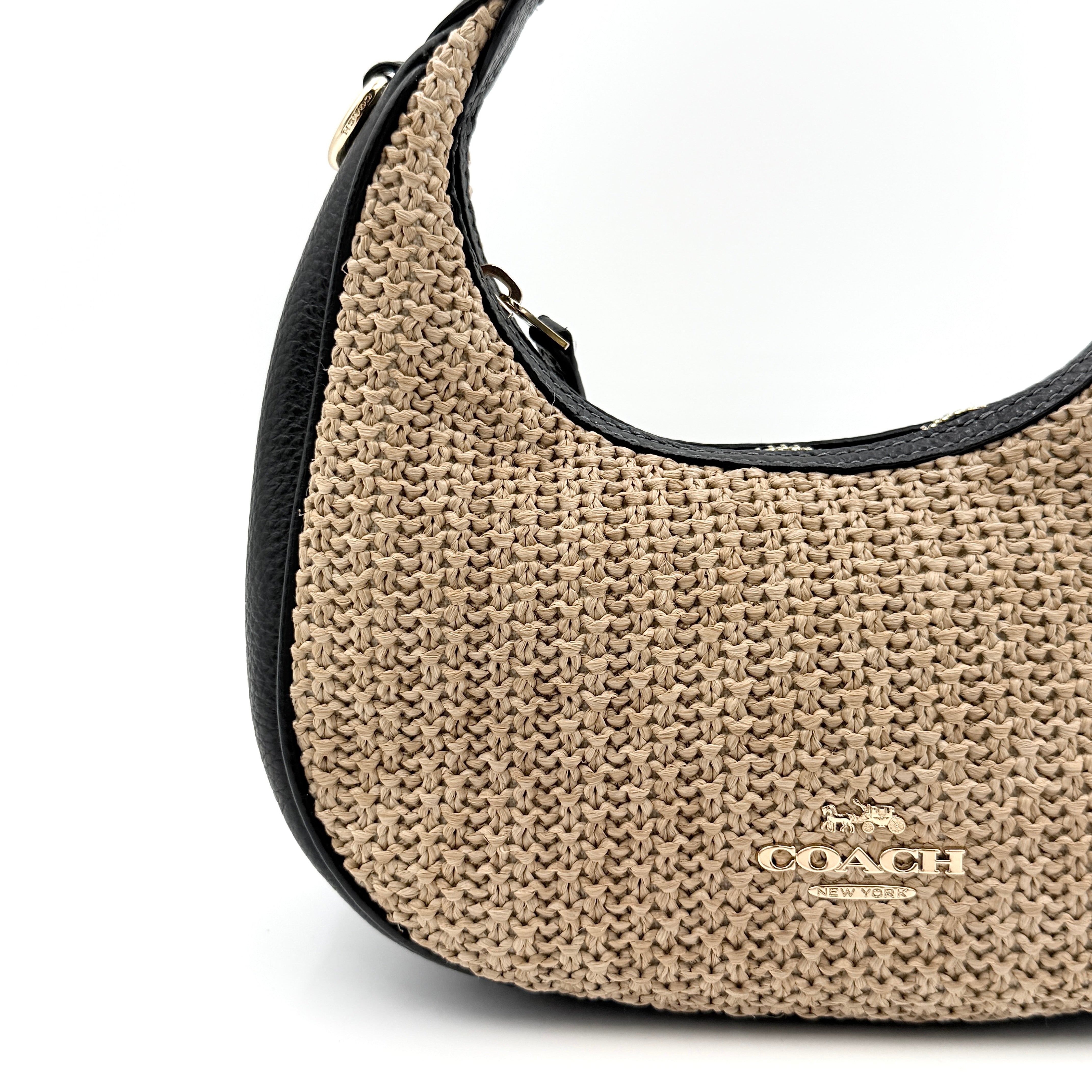 Coach Carmen Mini 2Way Shoulder Bag in beige and black with textured woven body, leather trim, and gold-tone hardware.