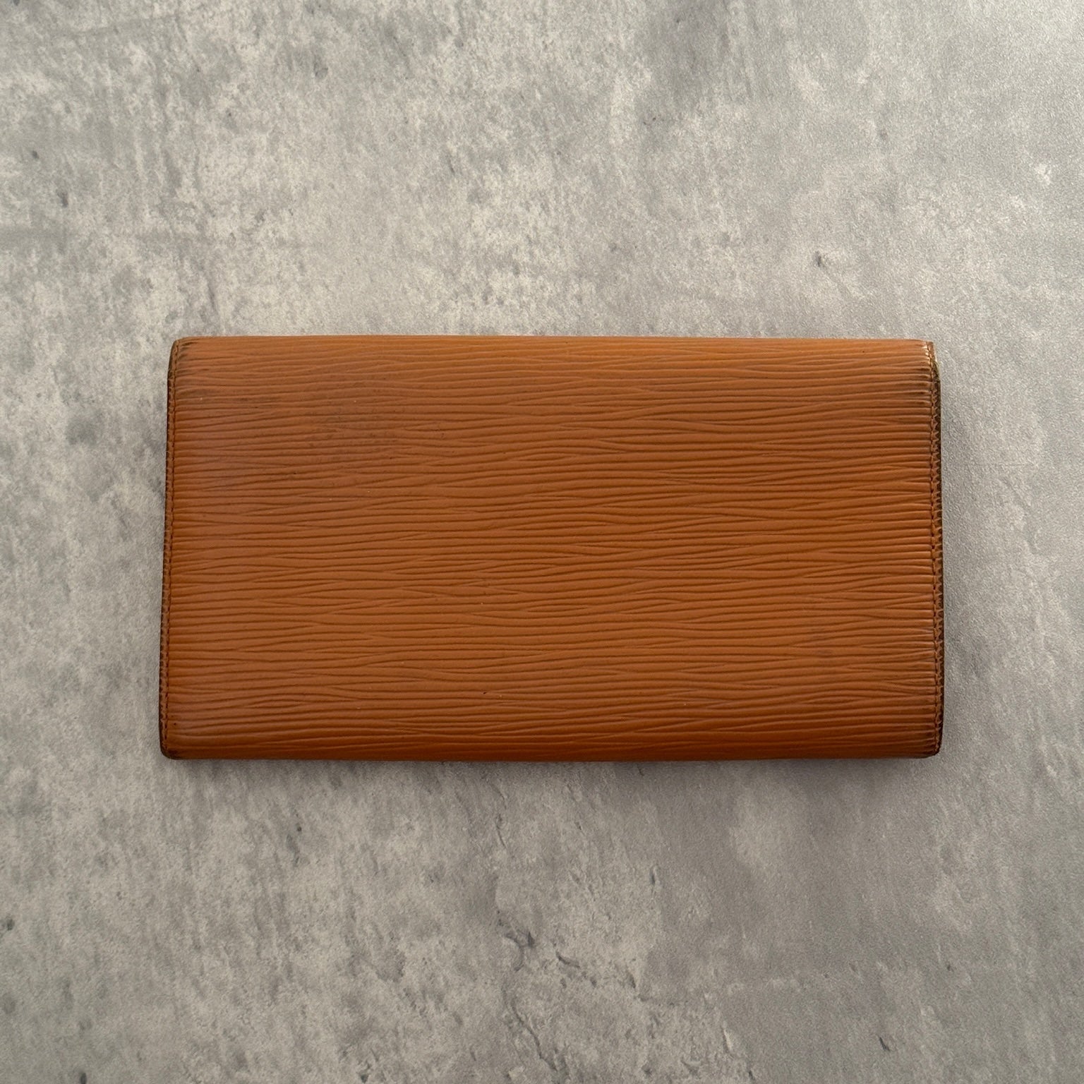 Louis Vuitton Cipango Gold Epi Leather Flap Continental Wallet in a discontinued warm golden hue, crafted from textured Epi leather with an embossed LV logo and multiple compartments.
