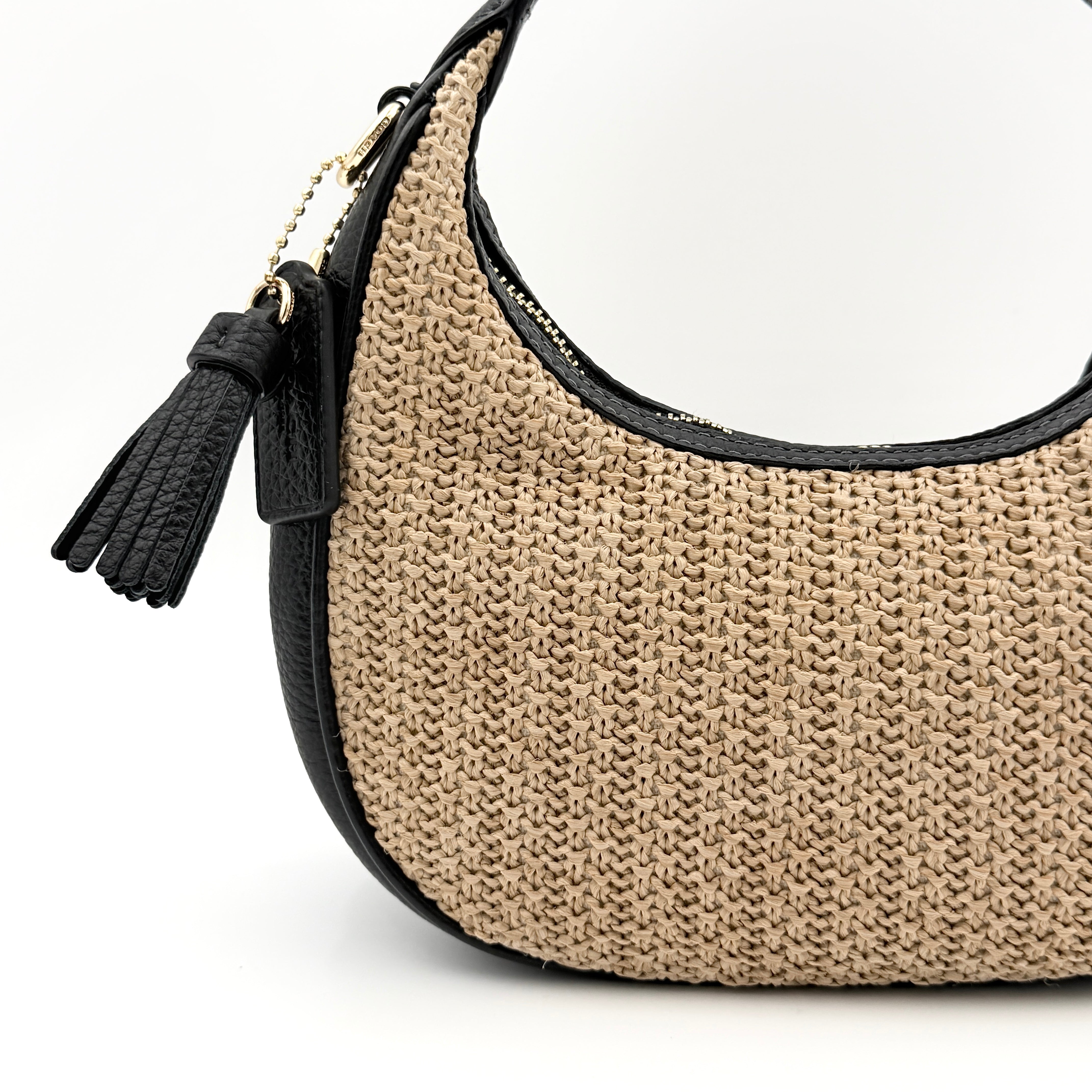 Coach Carmen Mini 2Way Shoulder Bag in beige and black with textured woven body, leather trim, and gold-tone hardware.