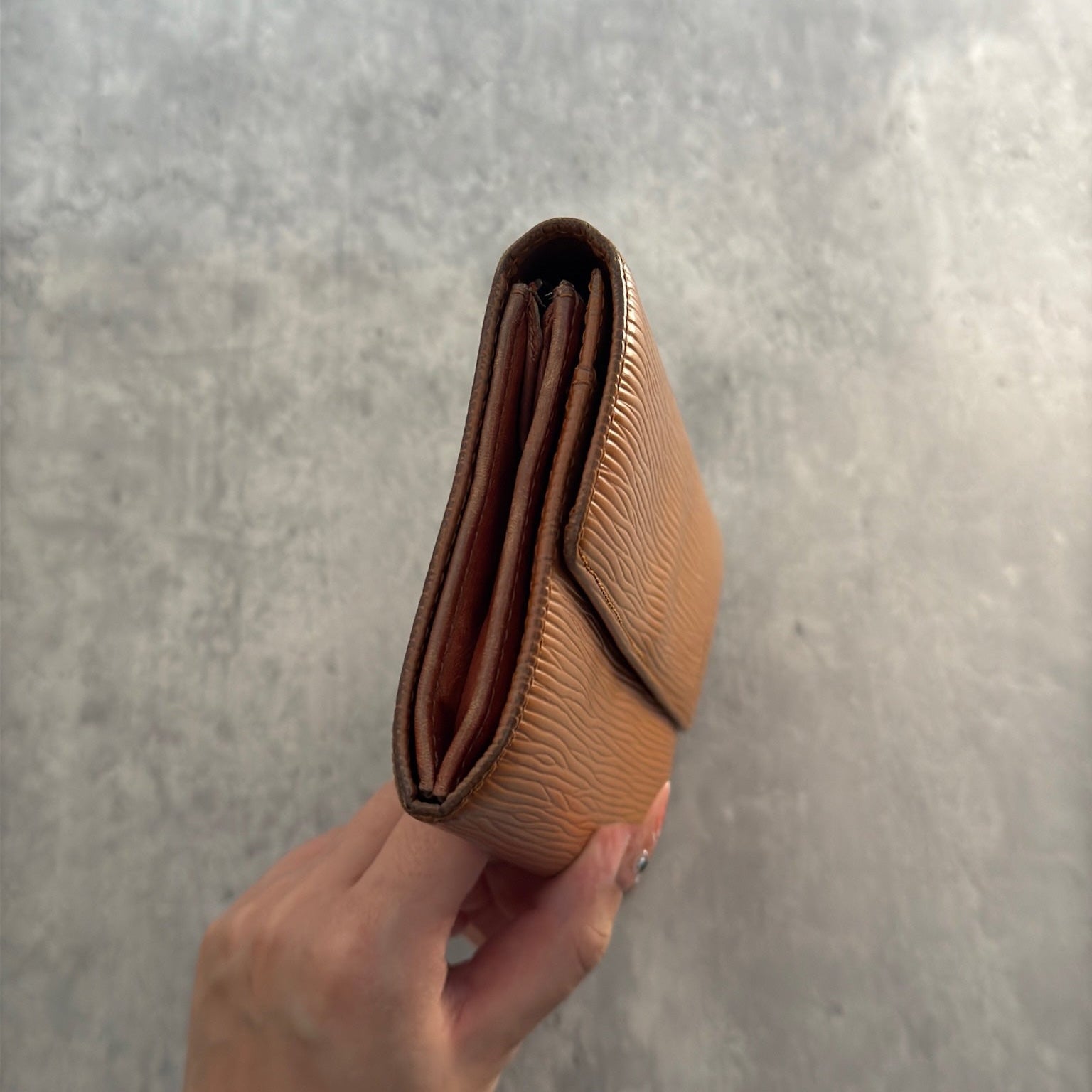 Louis Vuitton Cipango Gold Epi Leather Flap Continental Wallet in a discontinued warm golden hue, crafted from textured Epi leather with an embossed LV logo and multiple compartments.