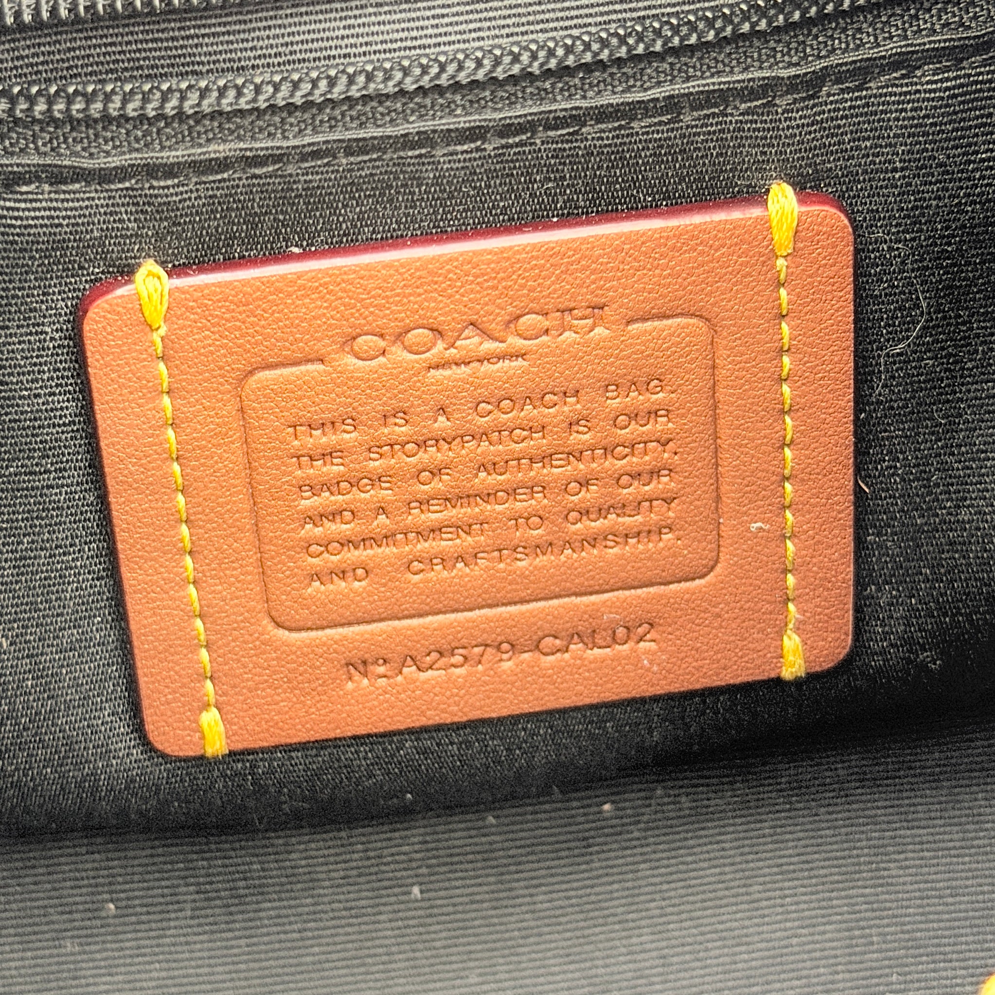 Coach Carmen Mini 2Way Shoulder Bag in beige and black with textured woven body, leather trim, and gold-tone hardware.