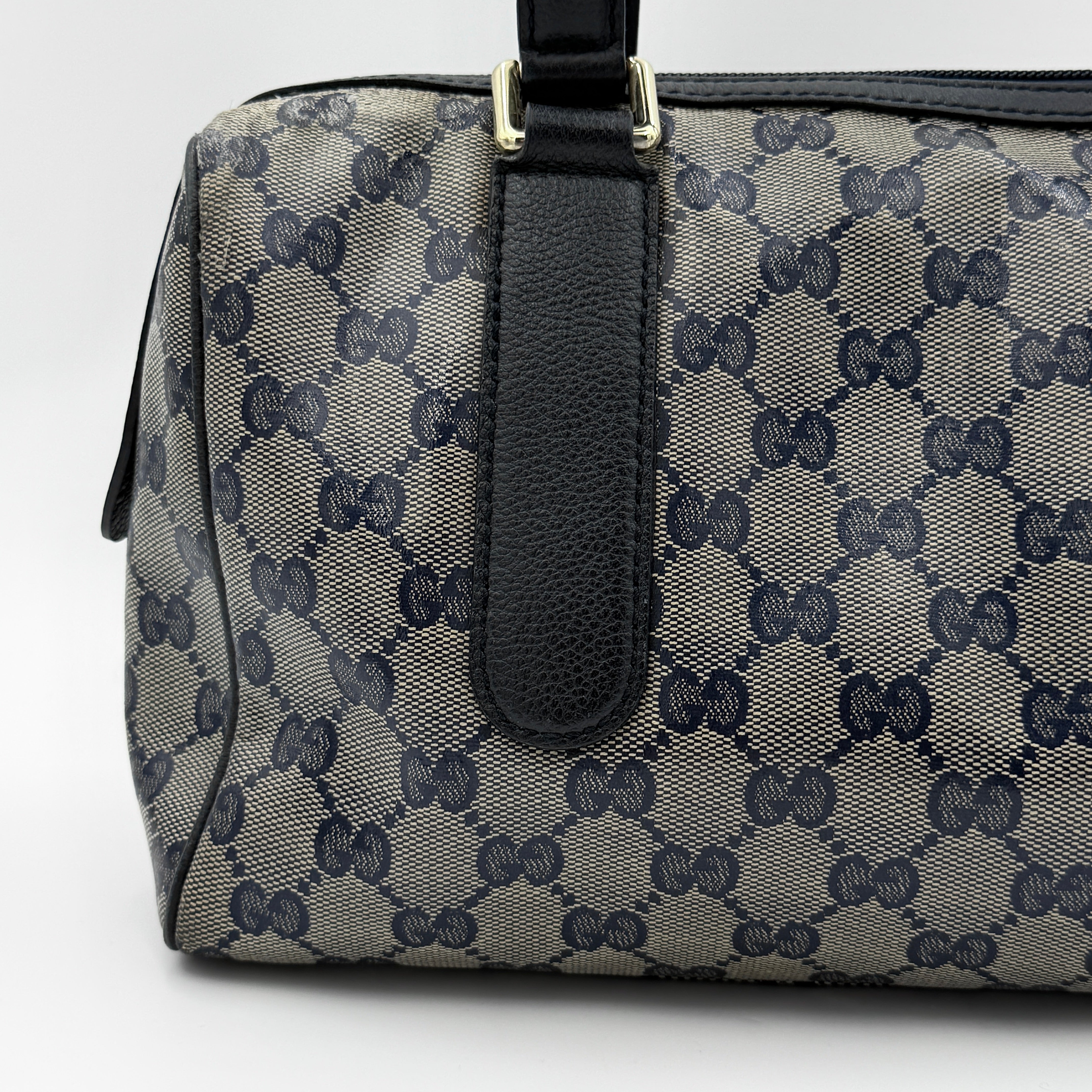 Front-facing view of the Gucci GG Monogram Crystal Boston Bag in grey and black with dual top handles and signature GG canvas.