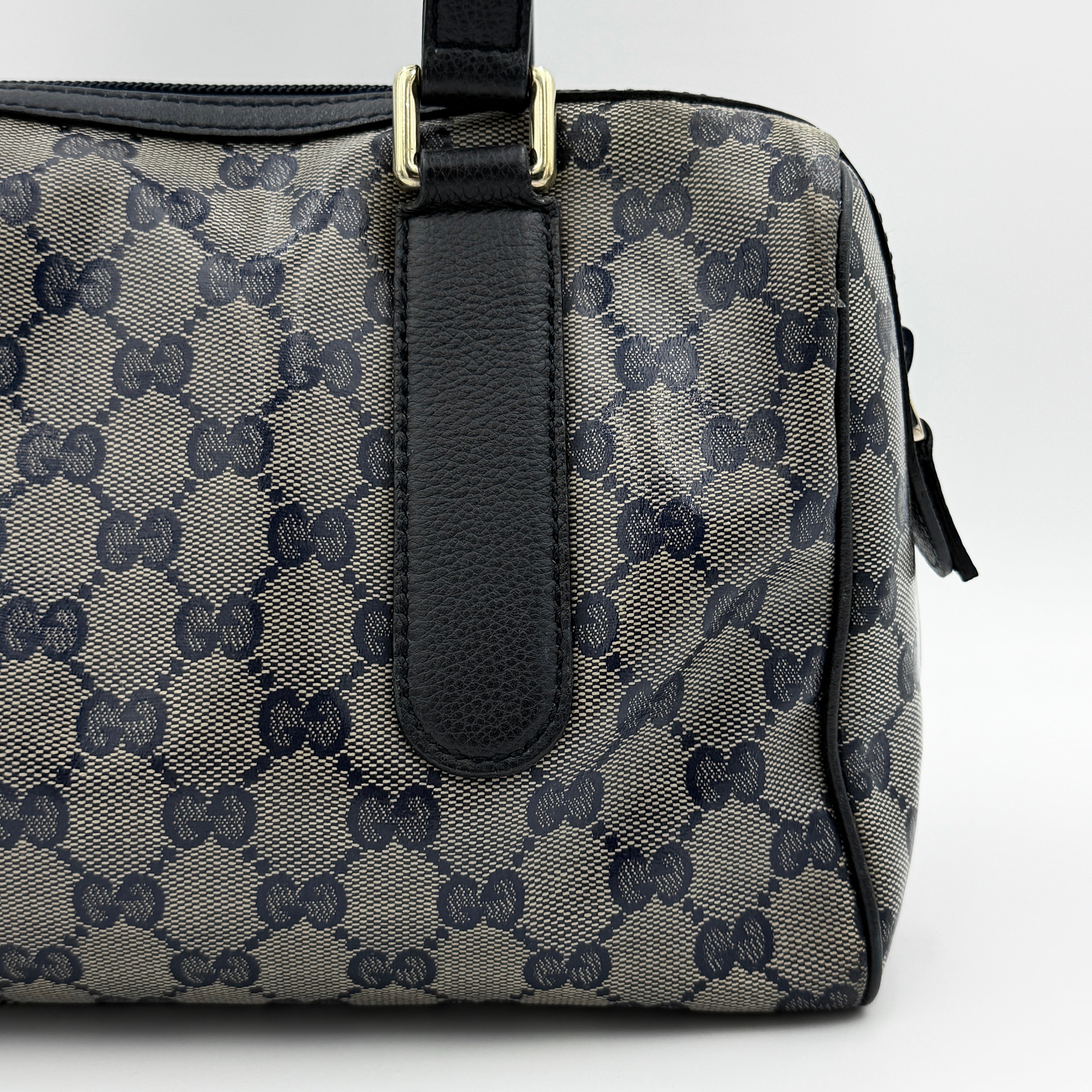 Front-facing view of the Gucci GG Monogram Crystal Boston Bag in grey and black with dual top handles and signature GG canvas.