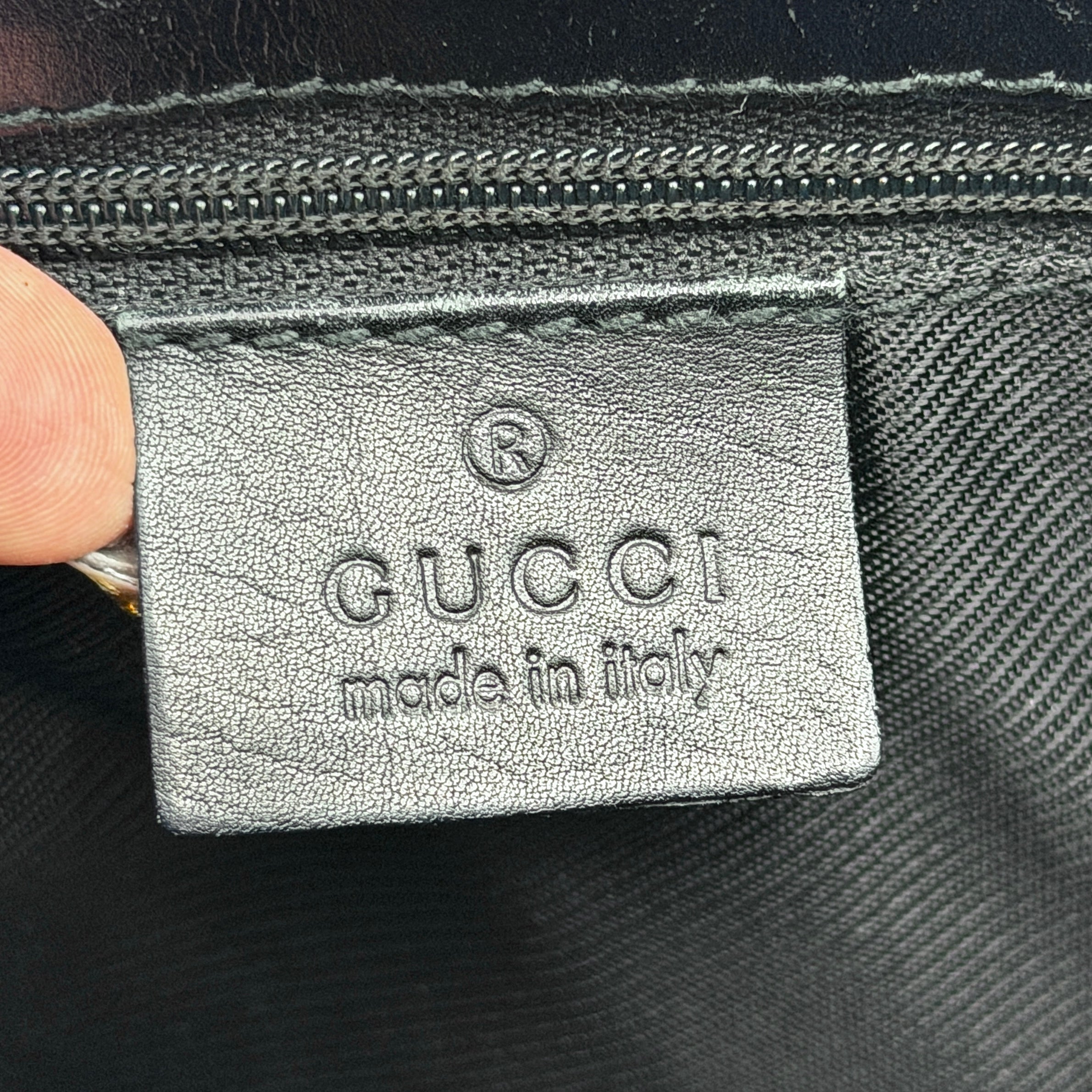 Gucci GG Monogram Bucket Shoulder Bag in black canvas and leather with silver-tone hardware, shown on a white background.