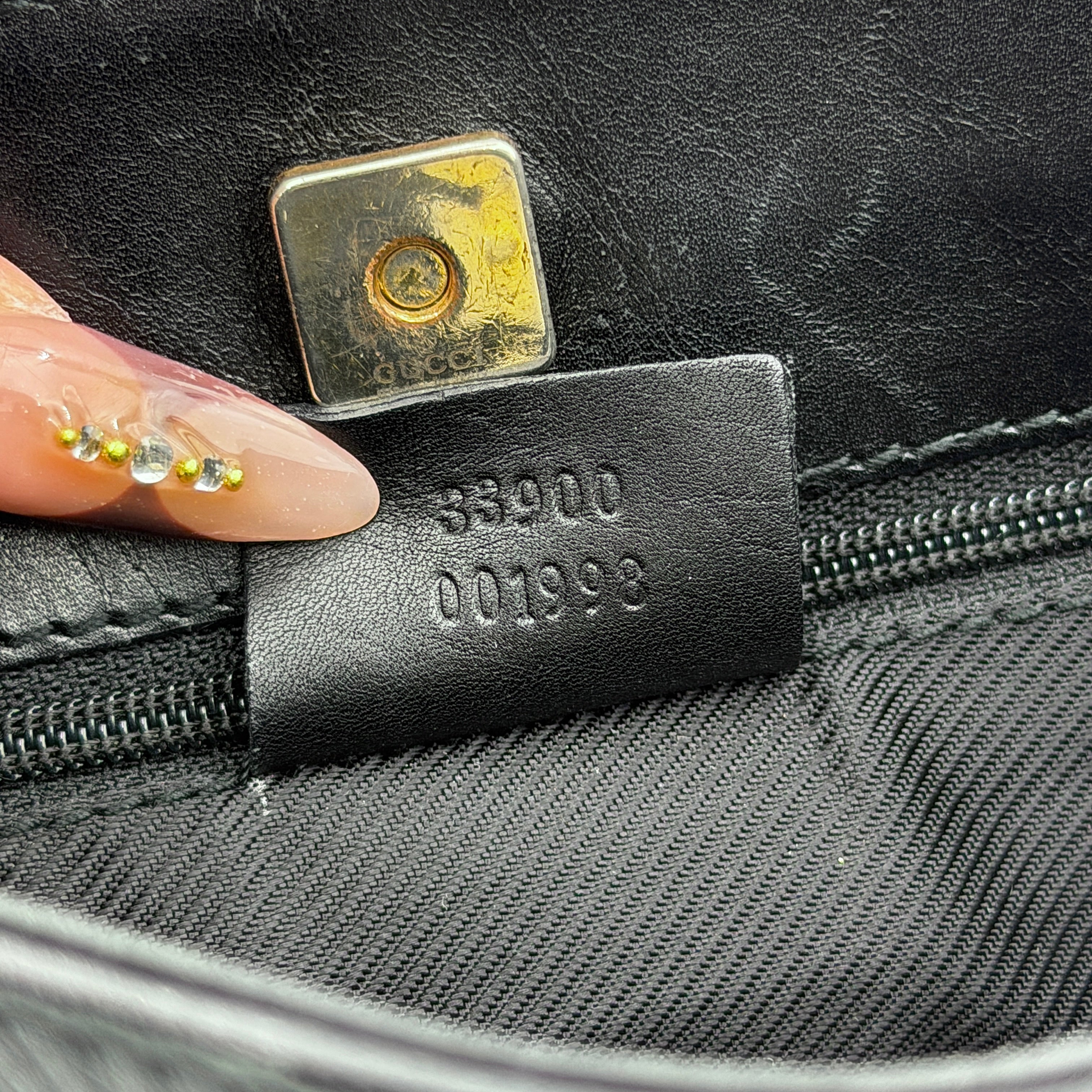 Gucci GG Monogram Bucket Shoulder Bag in black canvas and leather with silver-tone hardware, shown on a white background.