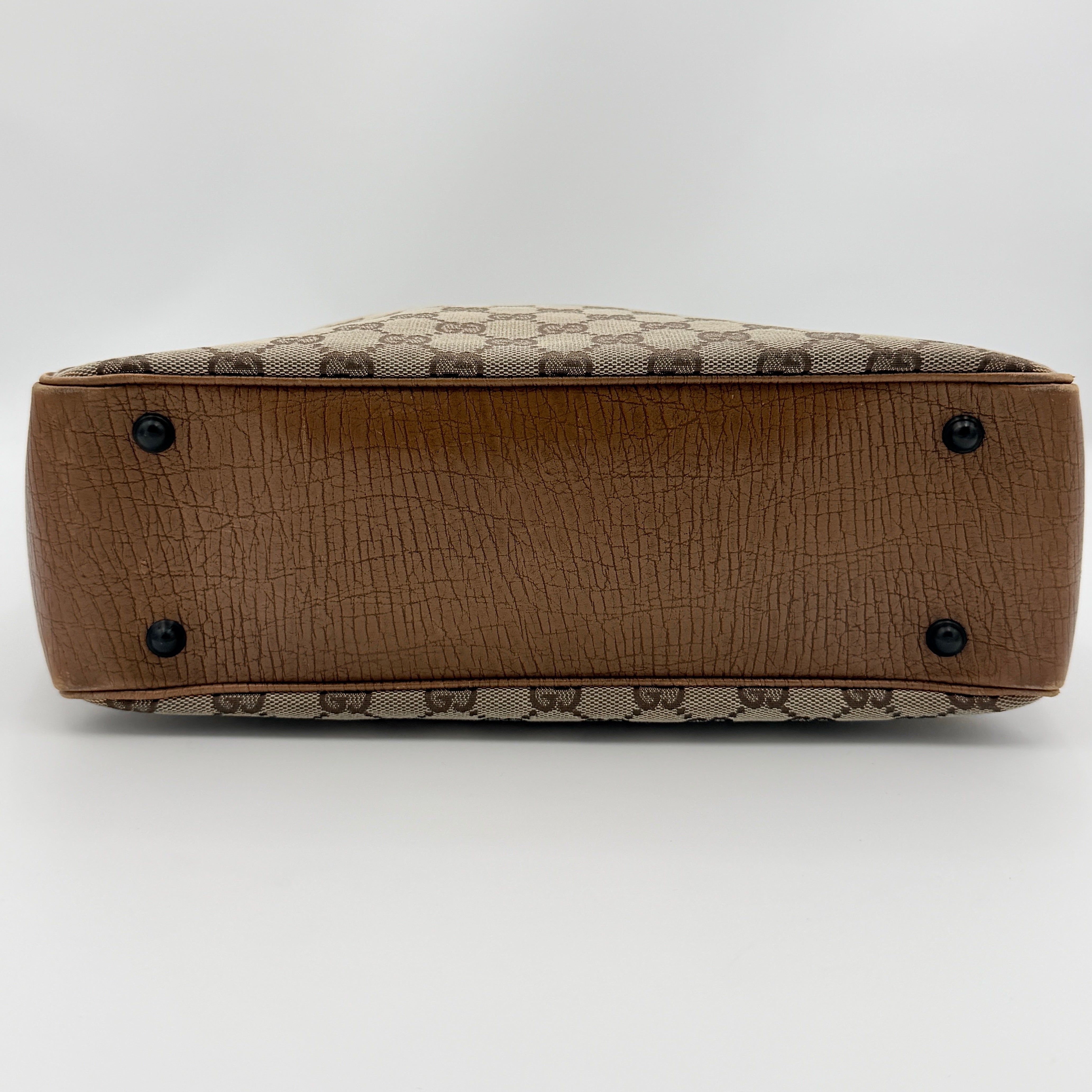 Gucci GG Monogram Bamboo Shoulder Bag in beige and brown canvas with bamboo top handles displayed upright.