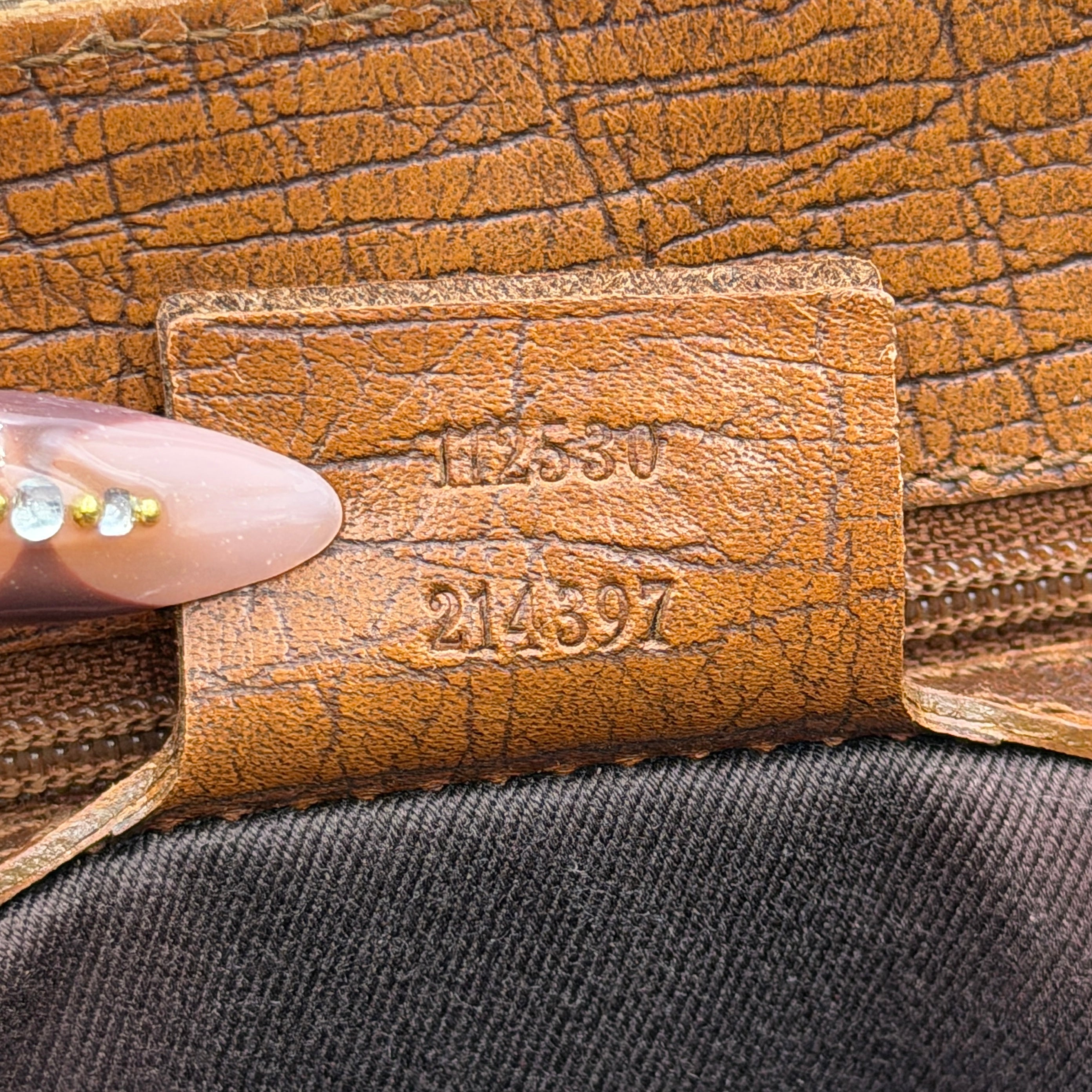 Gucci GG Monogram Bamboo Shoulder Bag in beige and brown canvas with bamboo top handles displayed upright.