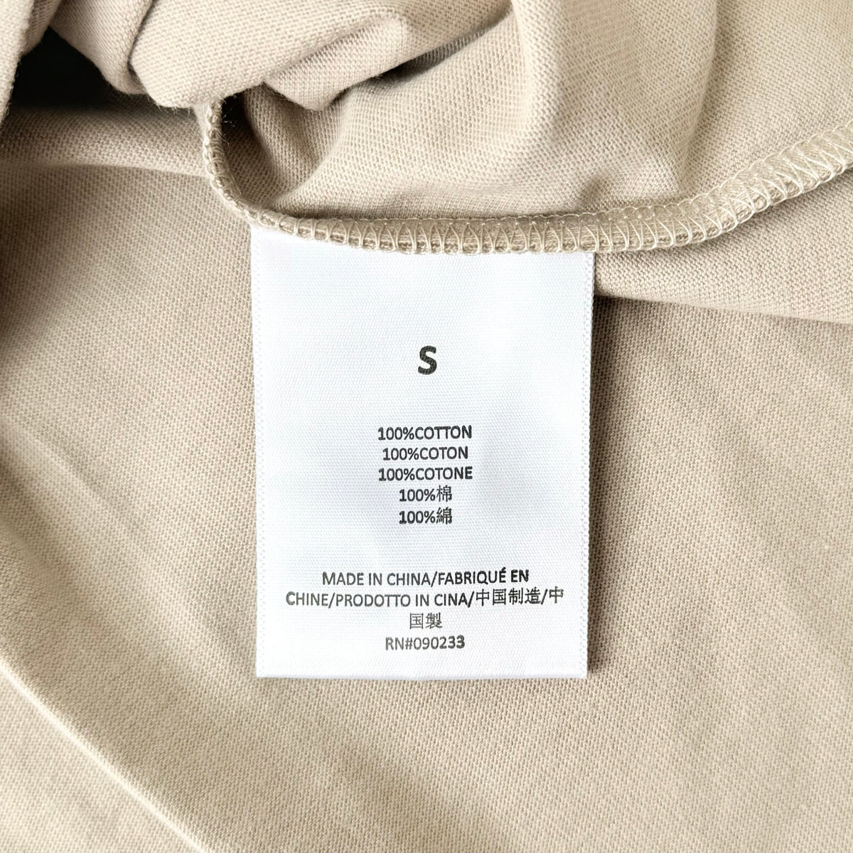Fear of God Essentials Embossed T-shirt in dusty beige with a structured mock neck and tonal logo detail.