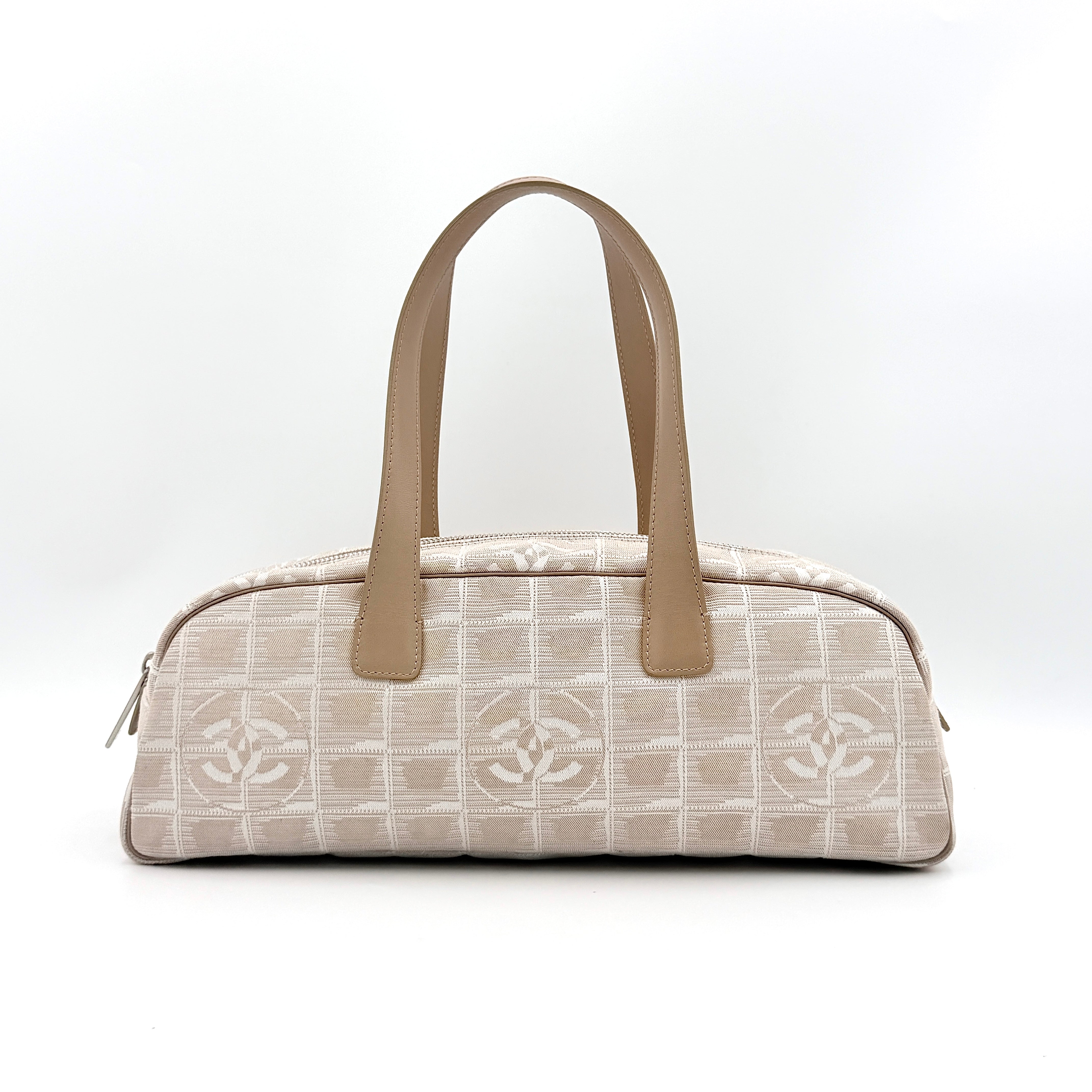 Chanel Travel Mini Boston Bag in beige nylon with CC motif and tan leather handles, shown in front view.
