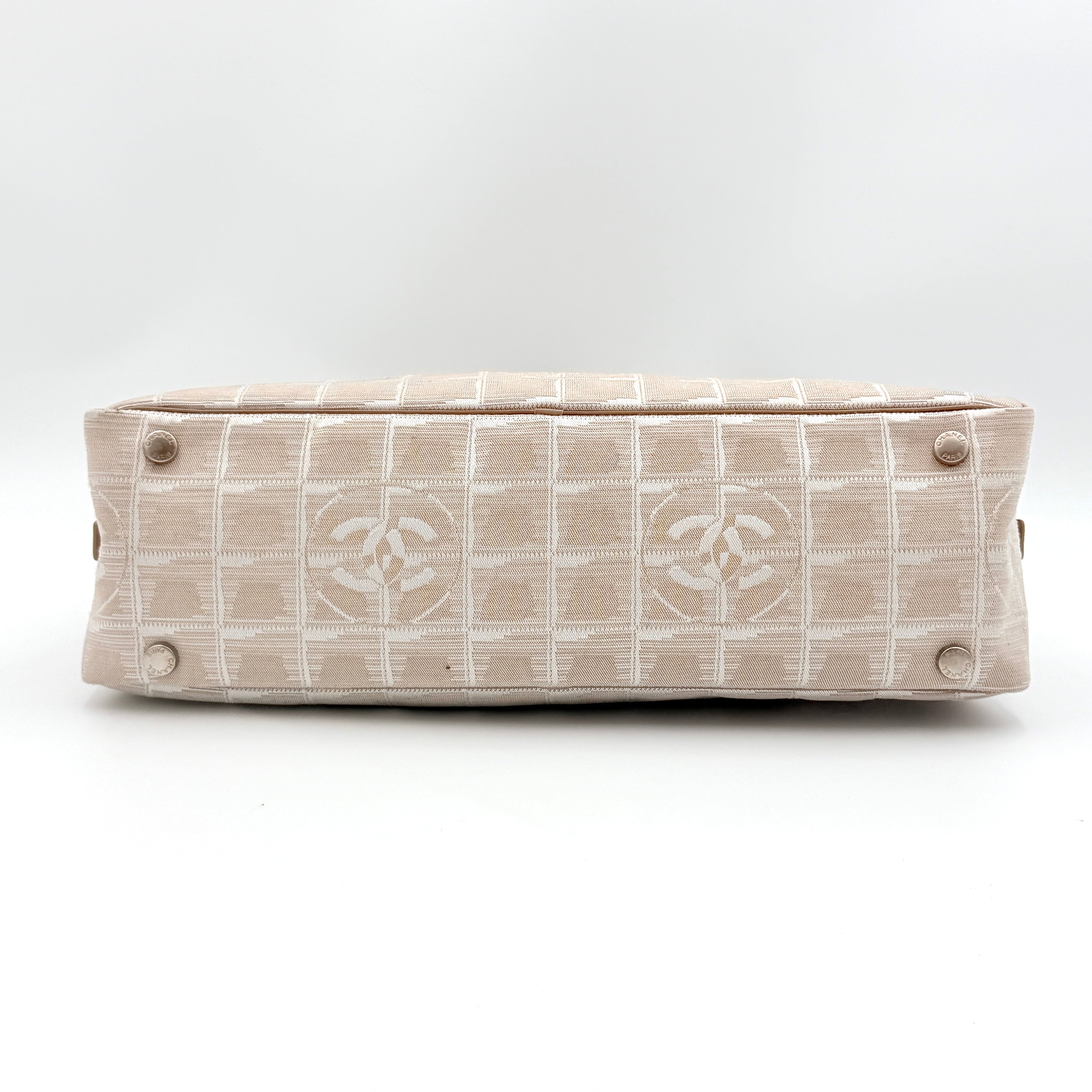 Chanel Travel Mini Boston Bag in beige nylon with CC motif and tan leather handles, shown in front view.