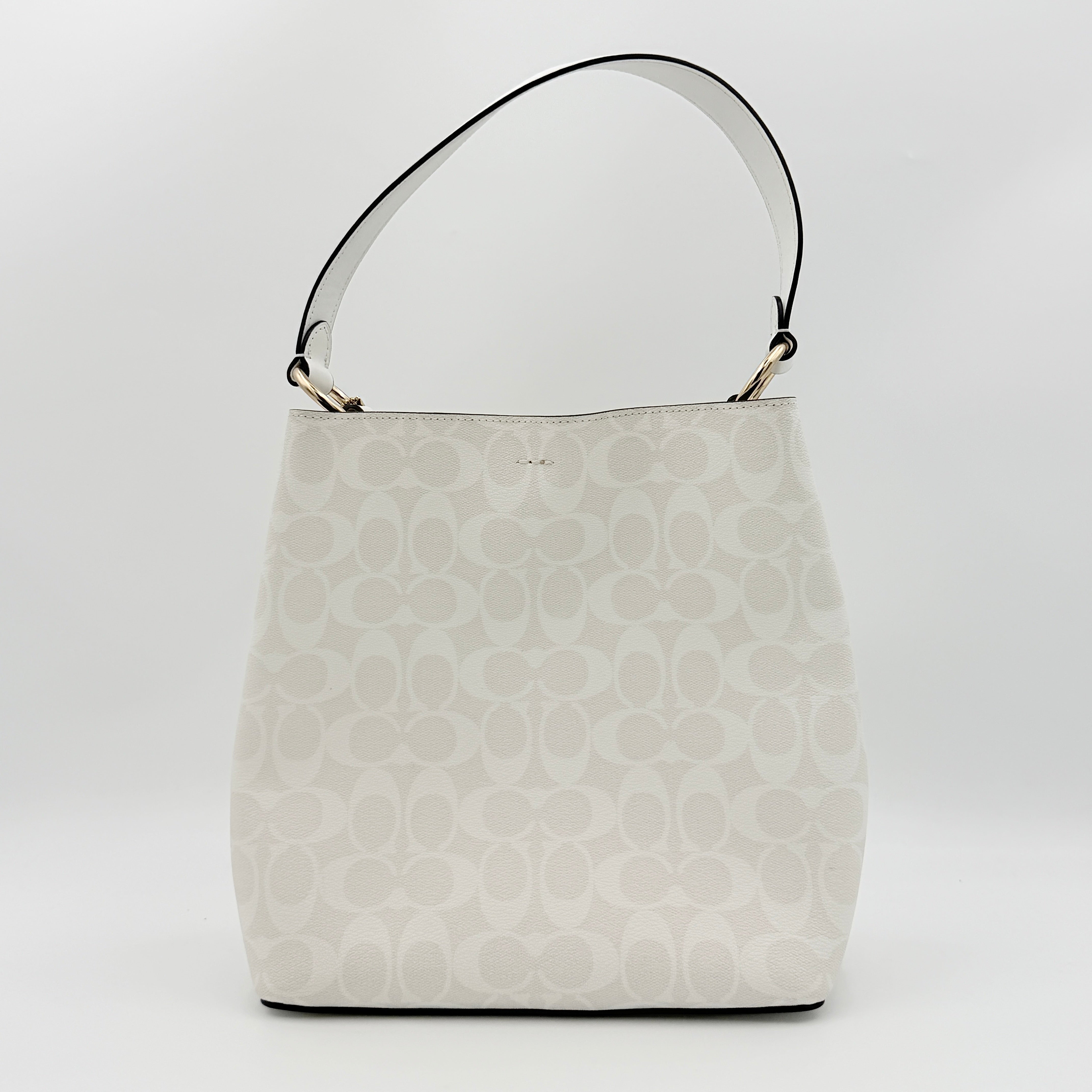 Coach Signature Town Bucket Shoulder Bag in white monogram canvas, shown with detachable strap and gold-tone hardware.