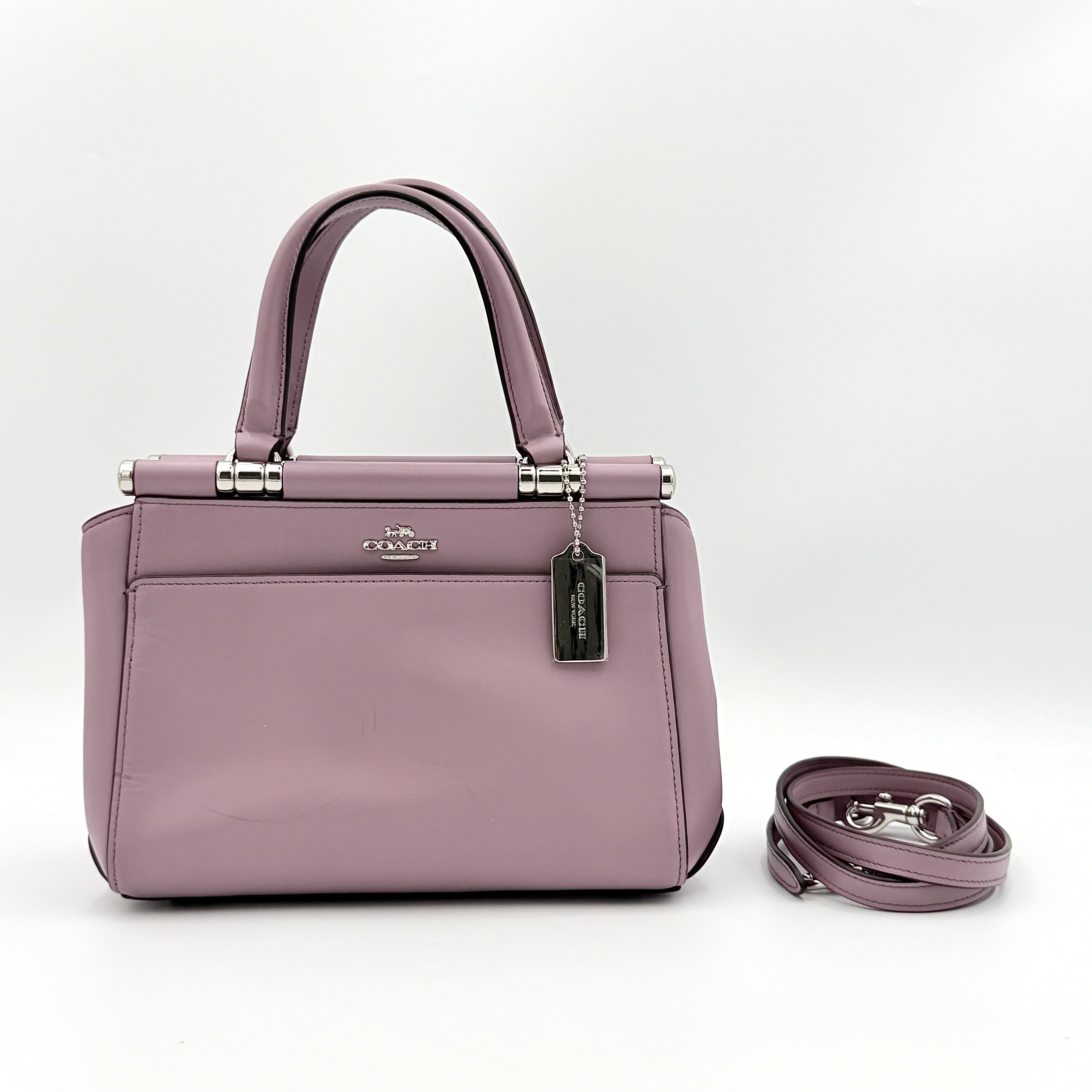 Coach Grace 20 bag in pink leather with silver hardware, shown with its detachable strap.