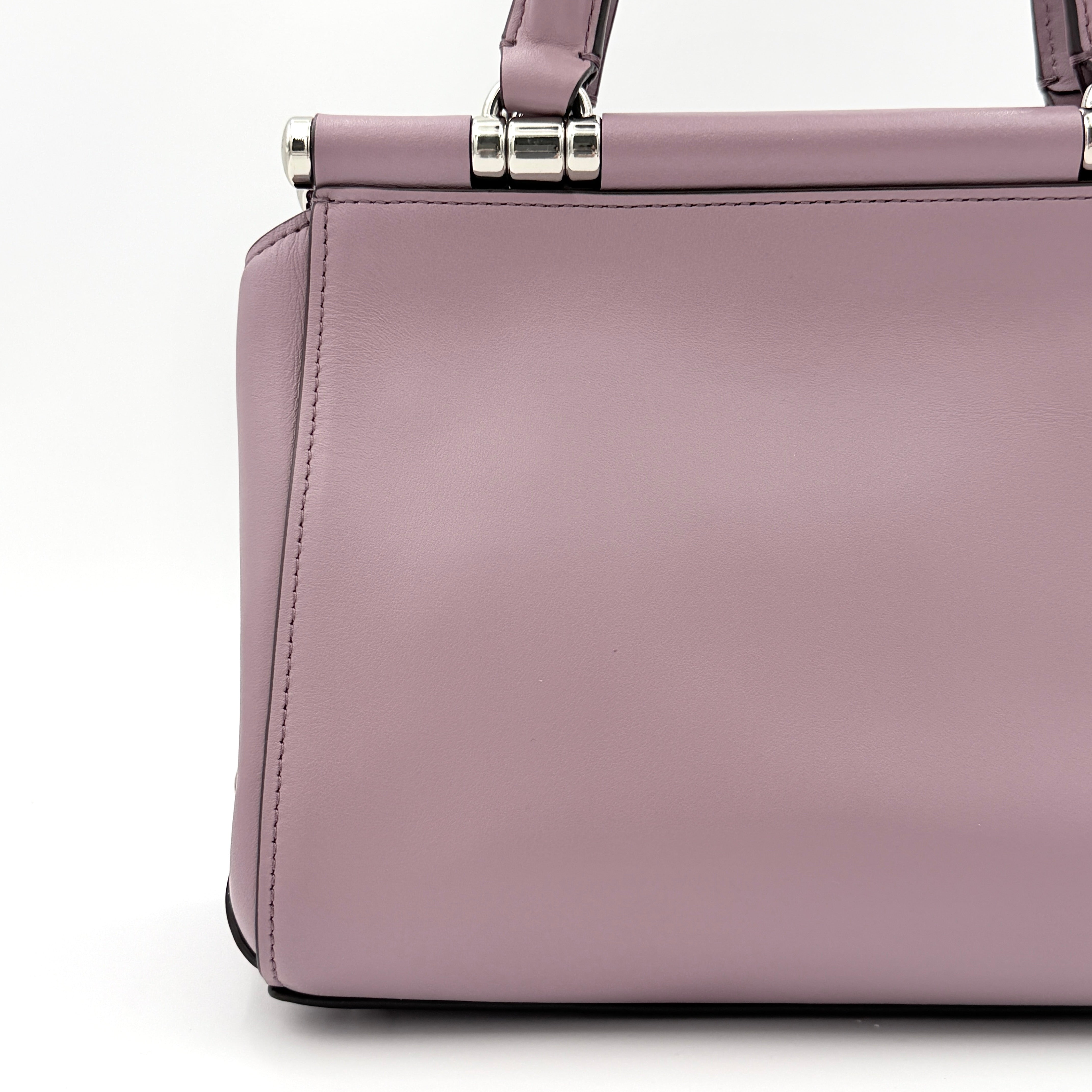 Coach Grace 20 bag in pink leather with silver hardware, shown with its detachable strap.