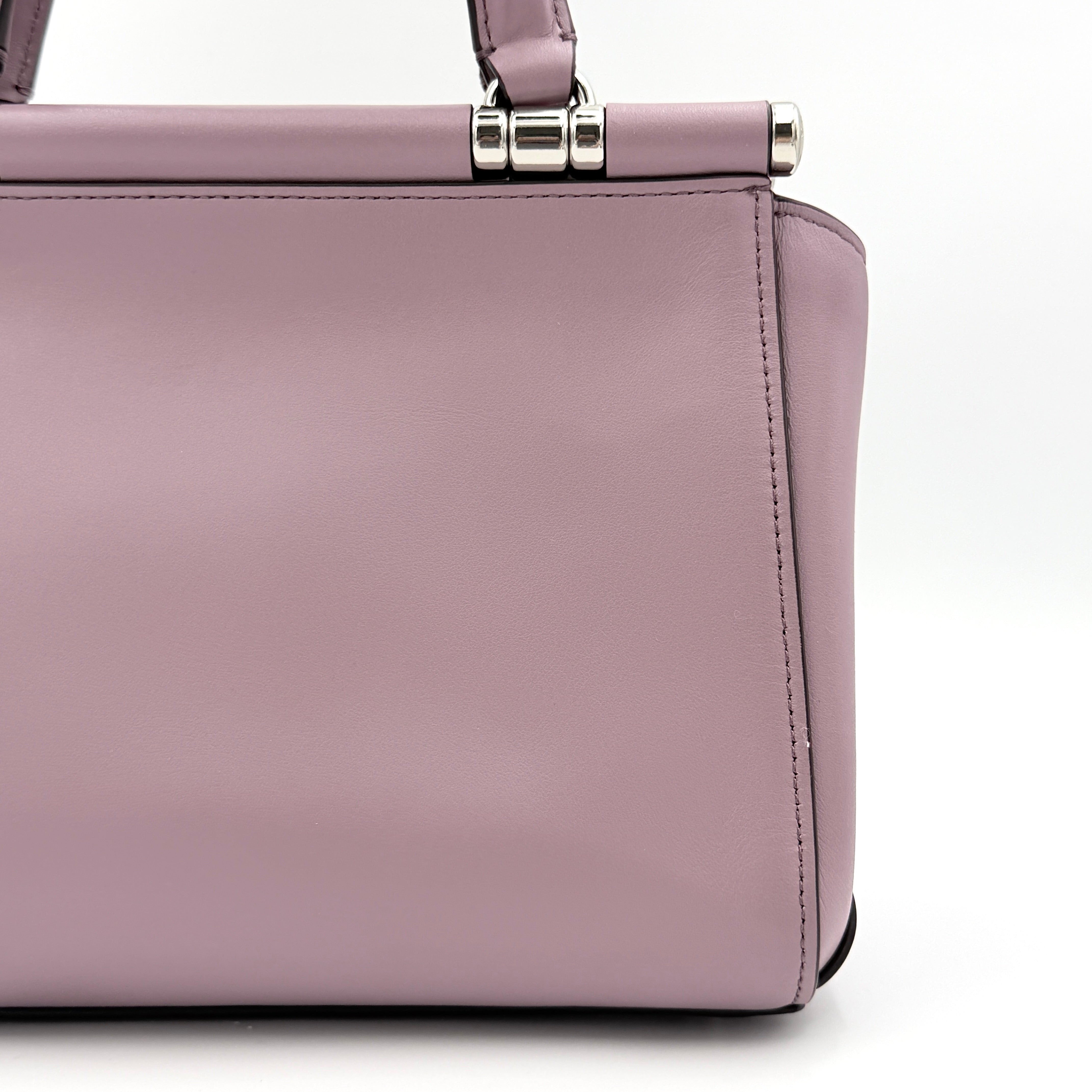 Coach Grace 20 bag in pink leather with silver hardware, shown with its detachable strap.