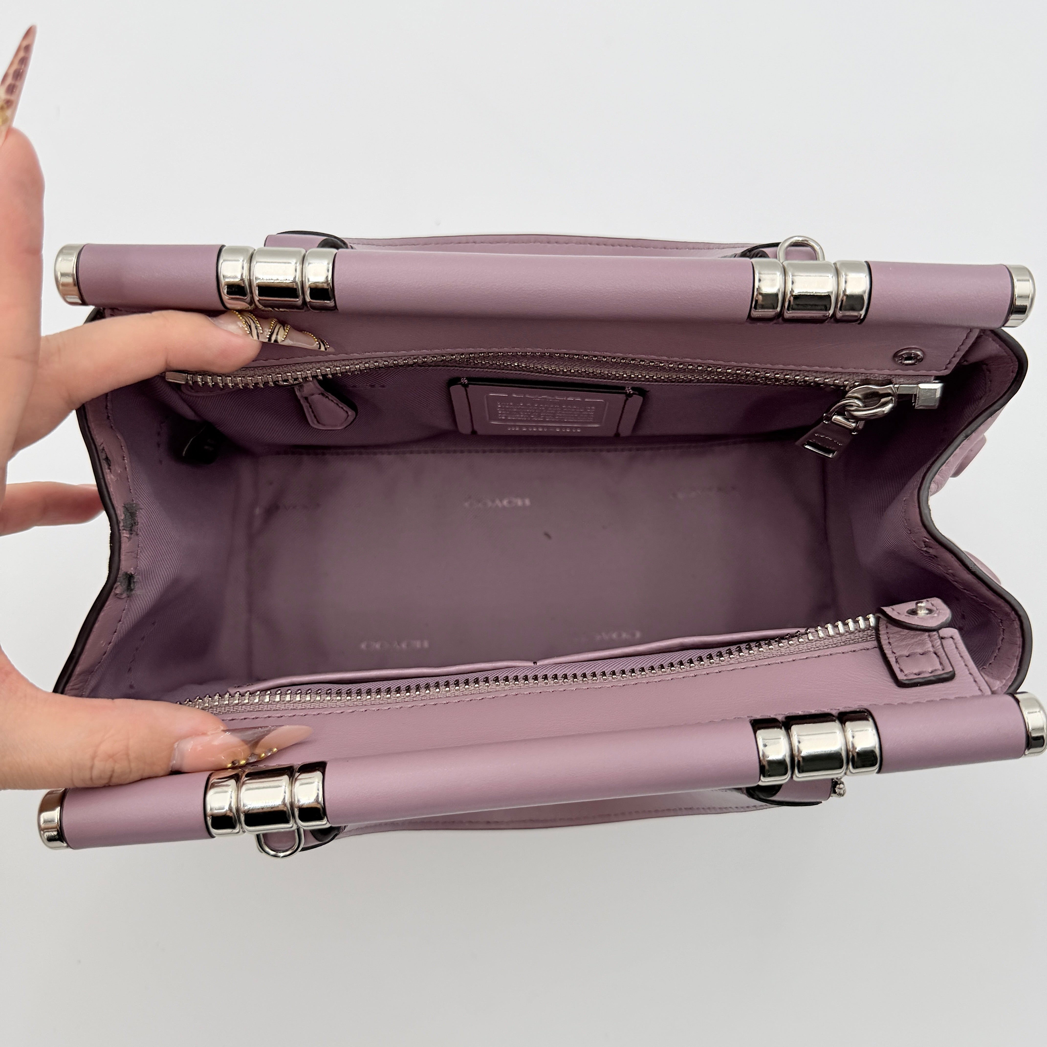 Coach Grace 20 bag in pink leather with silver hardware, shown with its detachable strap.