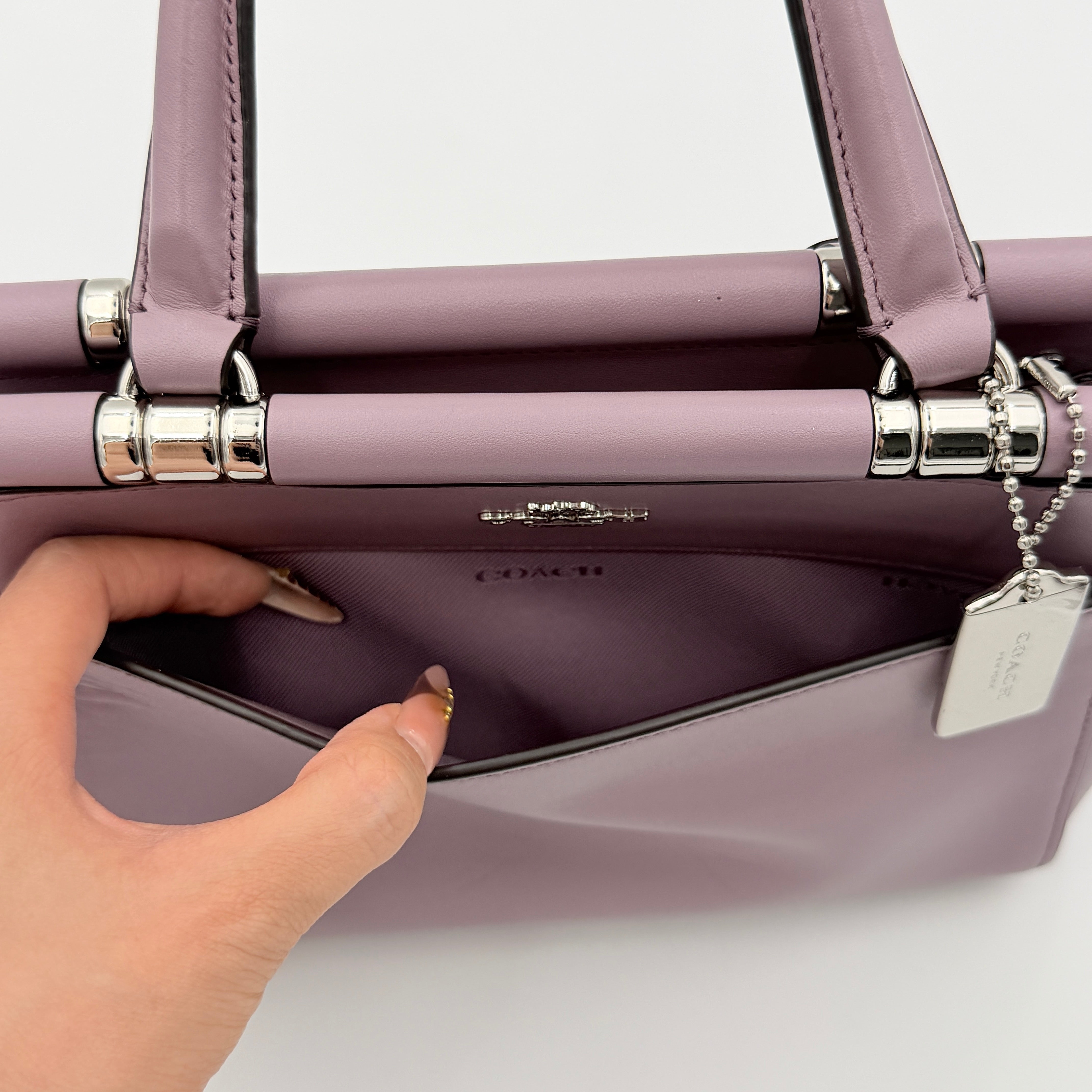 Coach Grace 20 bag in pink leather with silver hardware, shown with its detachable strap.