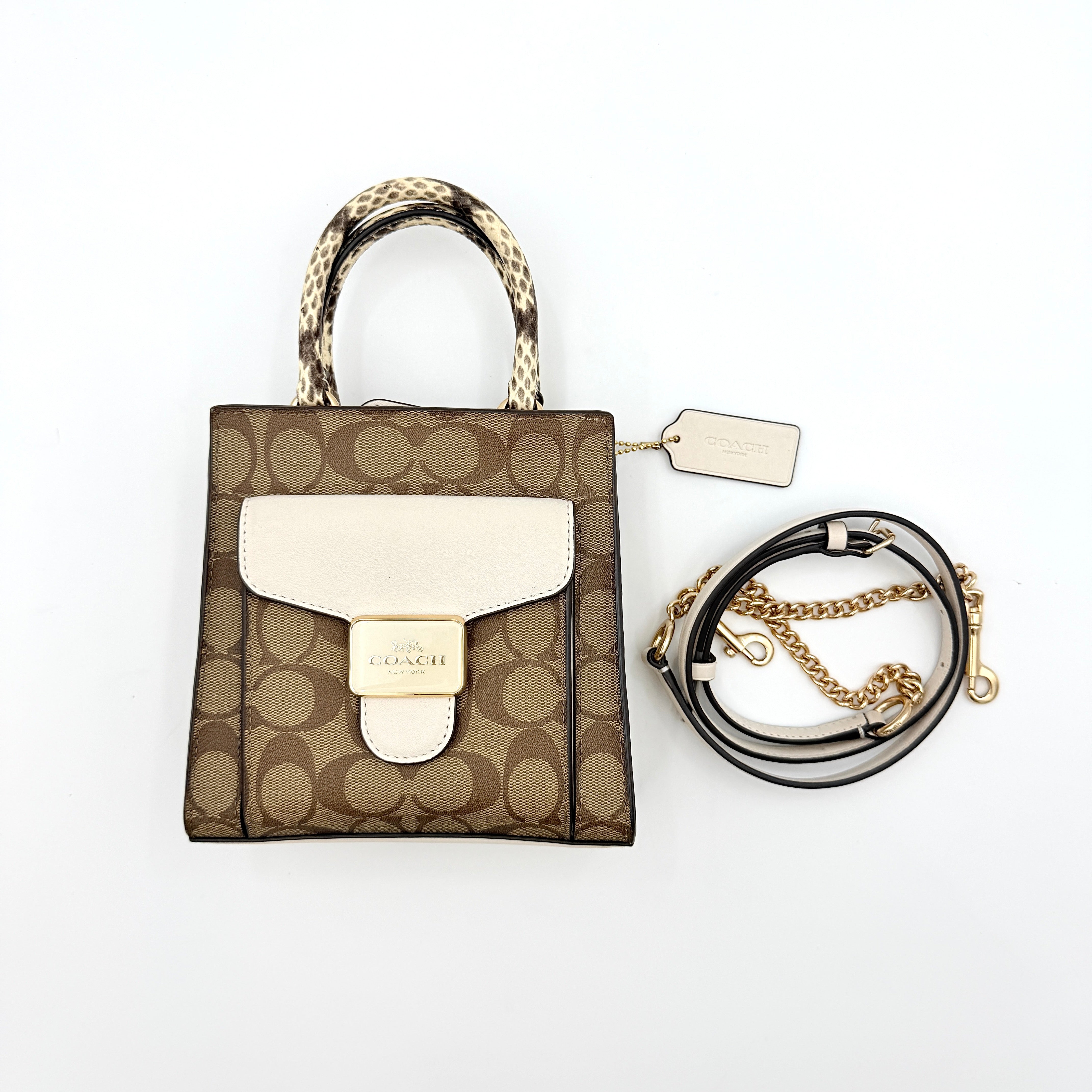 Coach Mini Pepper HandBag in beige canvas with white leather and snakeskin-effect handle, styled with detachable crossbody strap.
