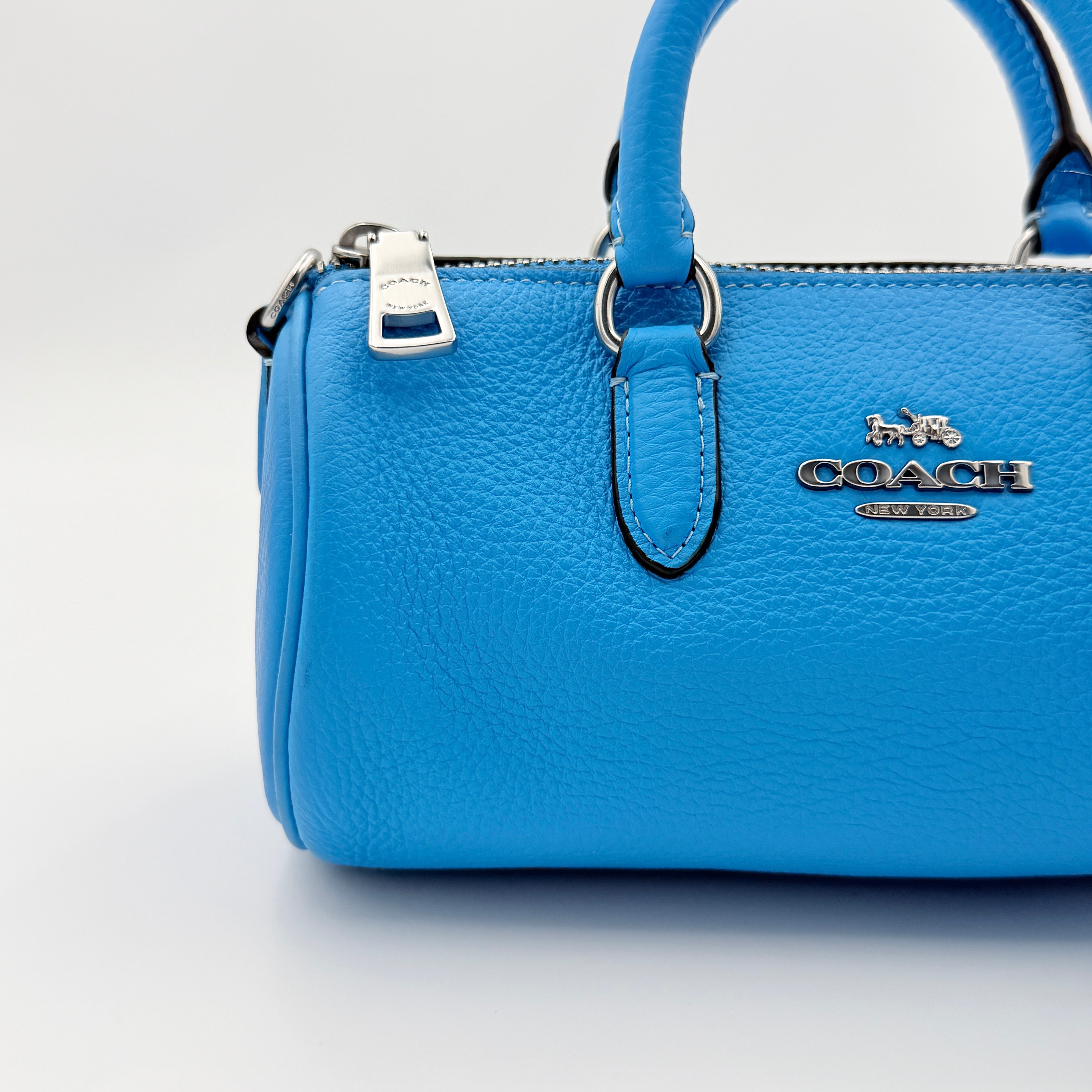 Coach 2Way Lacey Mini Boston Bag in blue pebbled leather with silver hardware and detachable strap, displayed against a clean background.