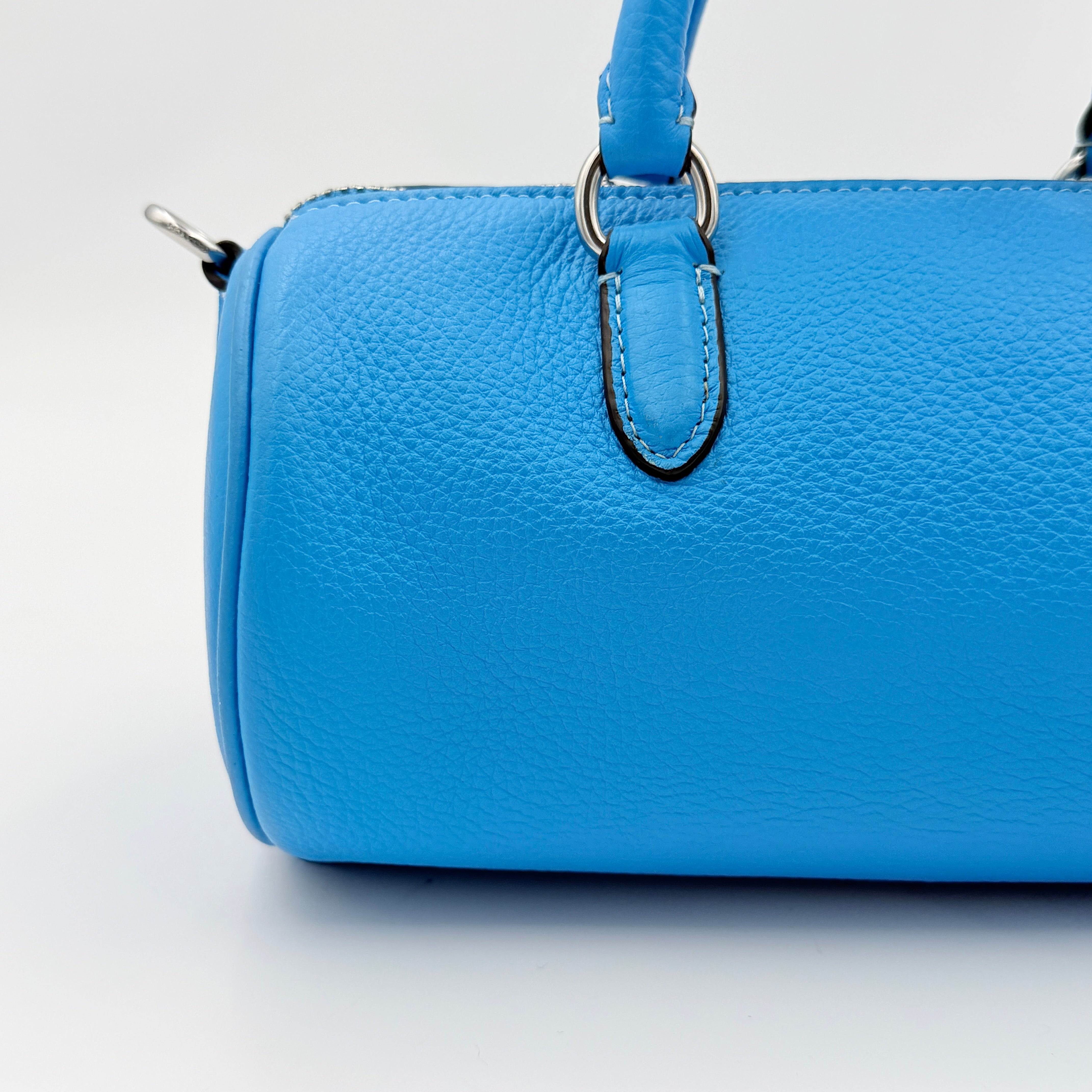 Coach 2Way Lacey Mini Boston Bag in blue pebbled leather with silver hardware and detachable strap, displayed against a clean background.