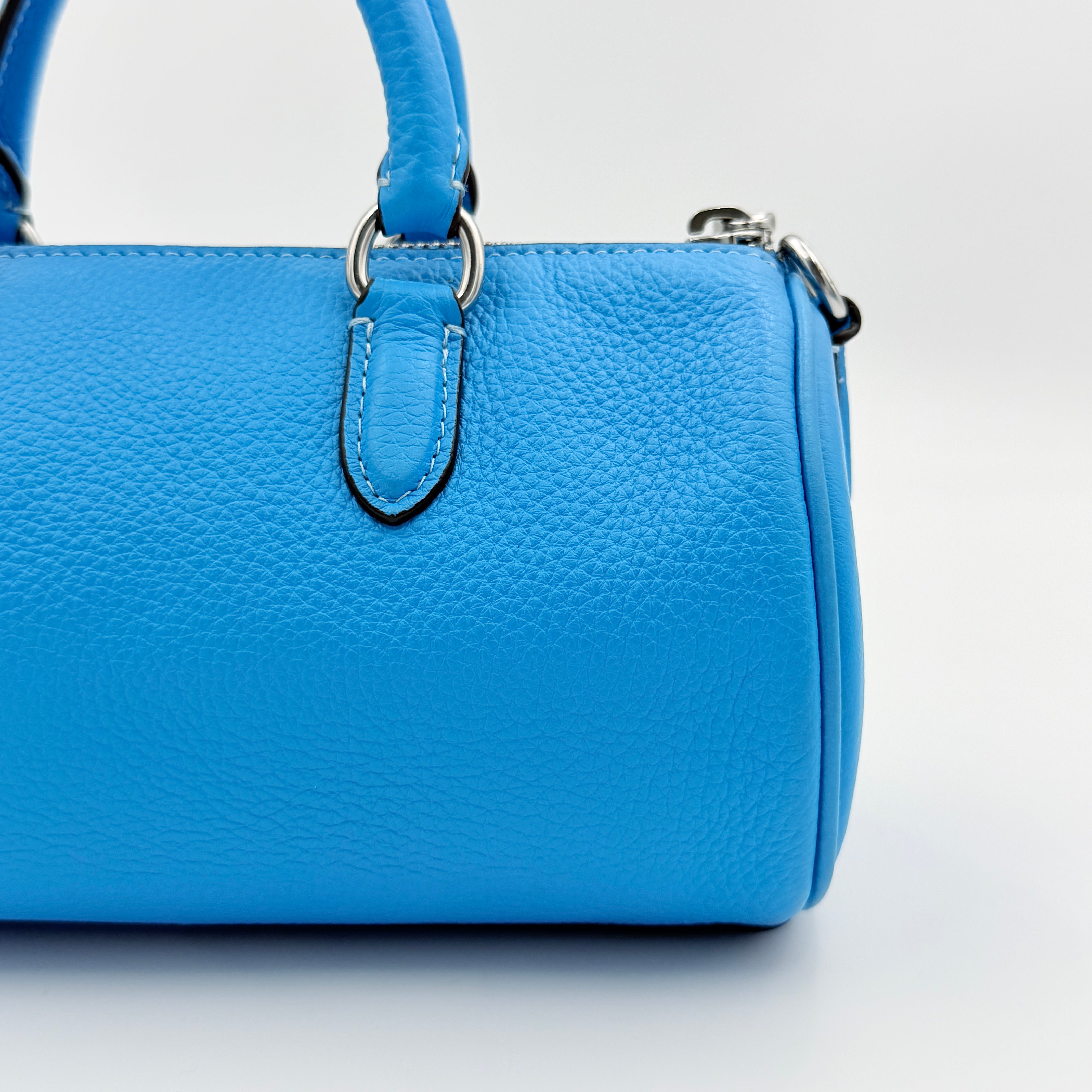 Coach 2Way Lacey Mini Boston Bag in blue pebbled leather with silver hardware and detachable strap, displayed against a clean background.