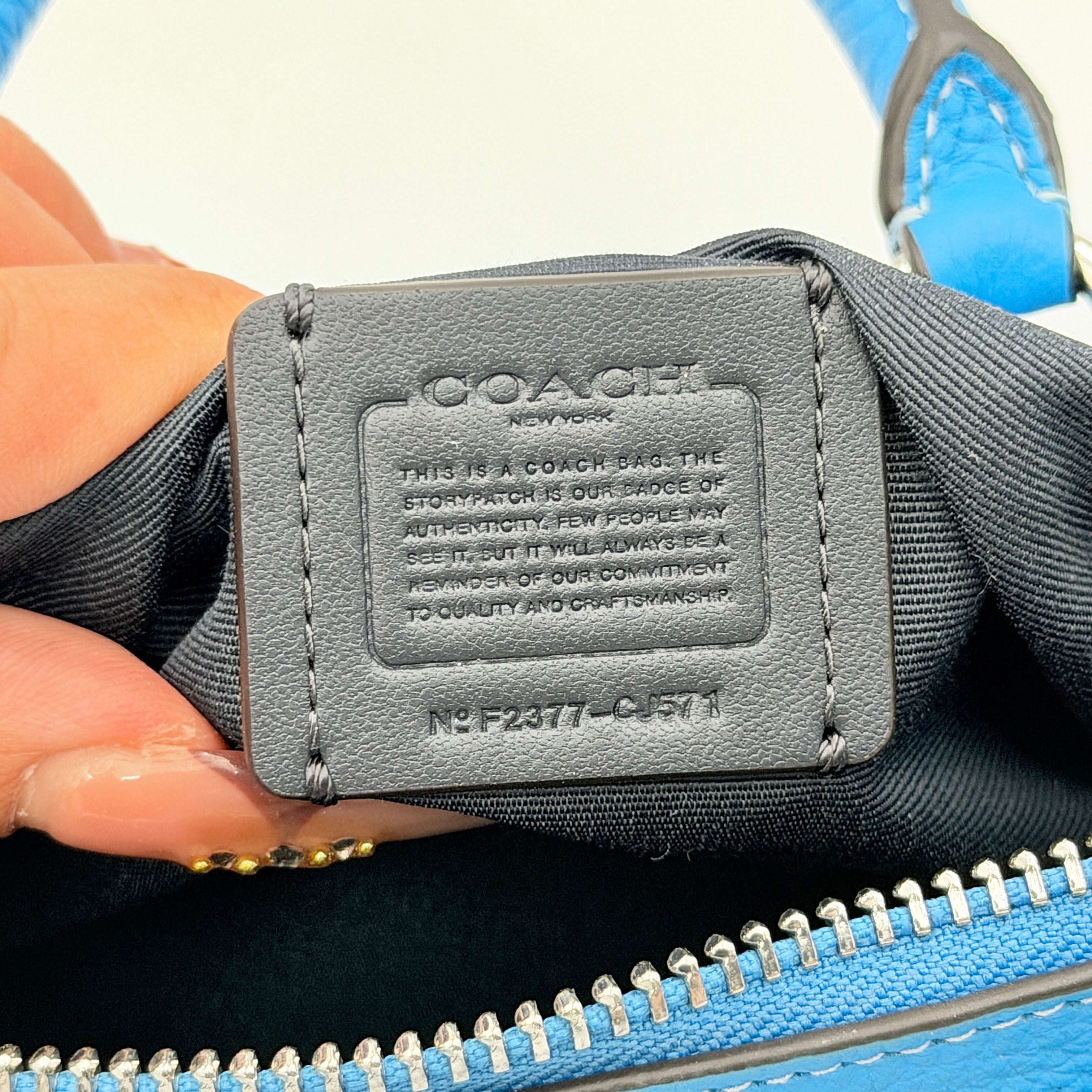 Coach 2Way Lacey Mini Boston Bag in blue pebbled leather with silver hardware and detachable strap, displayed against a clean background.