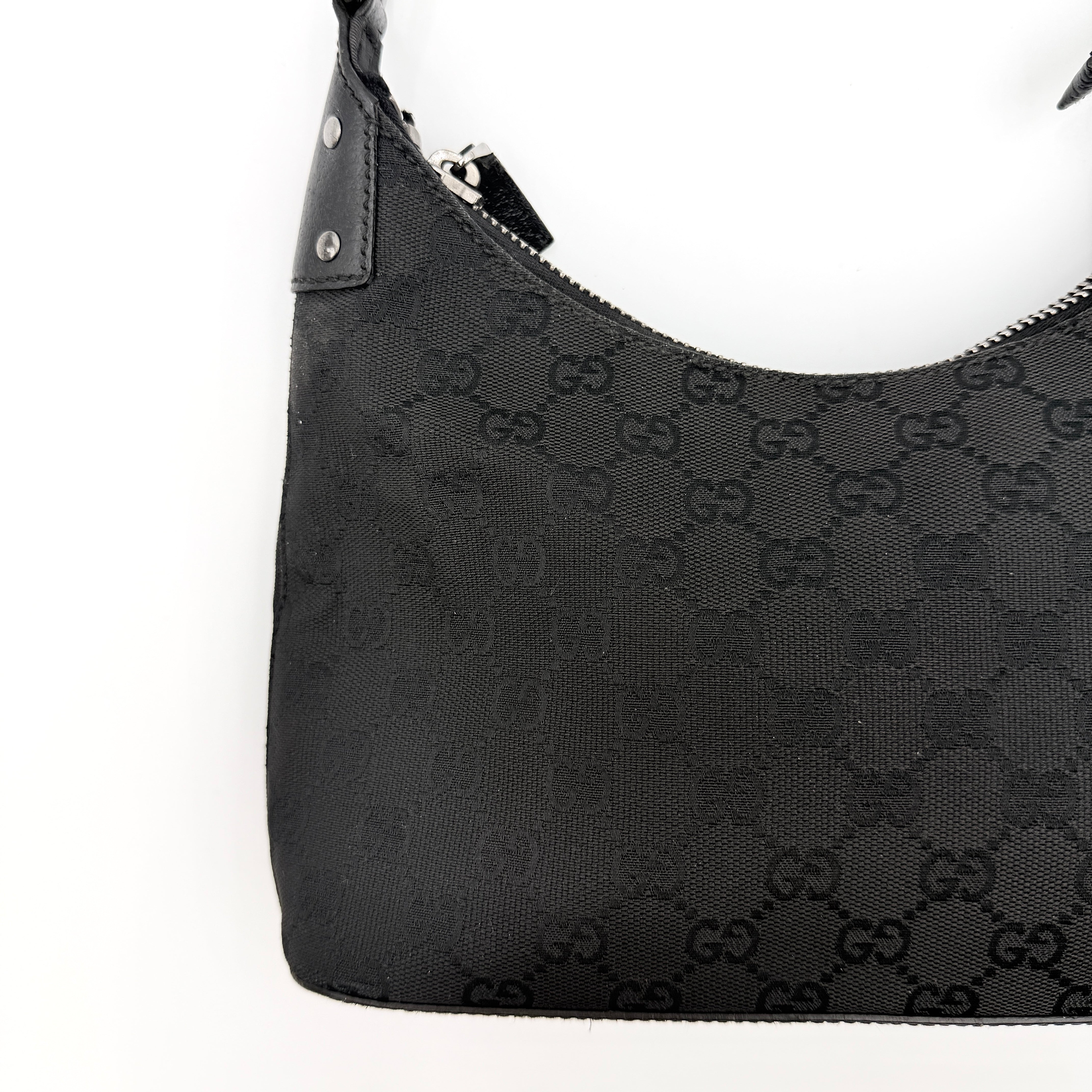 Gucci GG Monogram Lock Hobo Shoulder Bag in black jacquard canvas with leather trim and silver-tone hardware, shown on a white background.